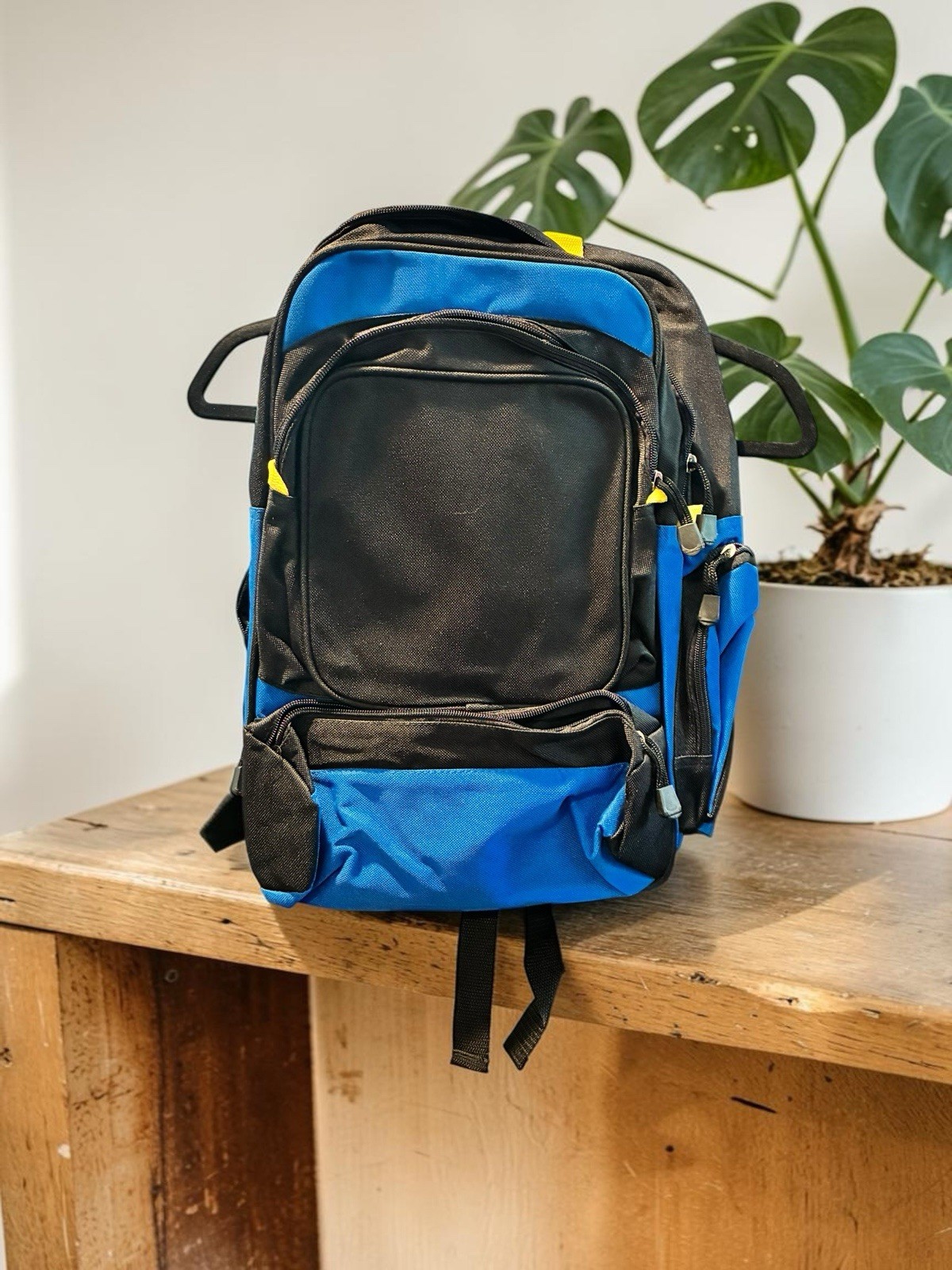Black And Blue Backpack With Many Pockets.