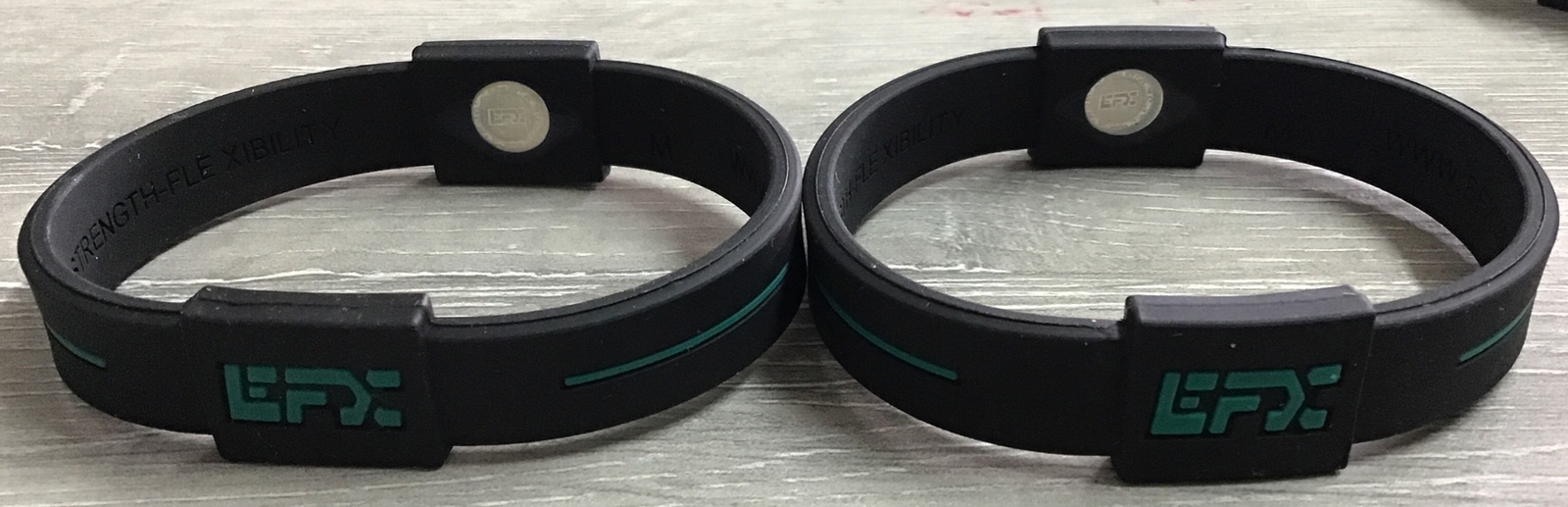 (LOT OF 2) EFX Hologram Sport Balance Wristband Black/Turquoise M- NEW- NO BOX