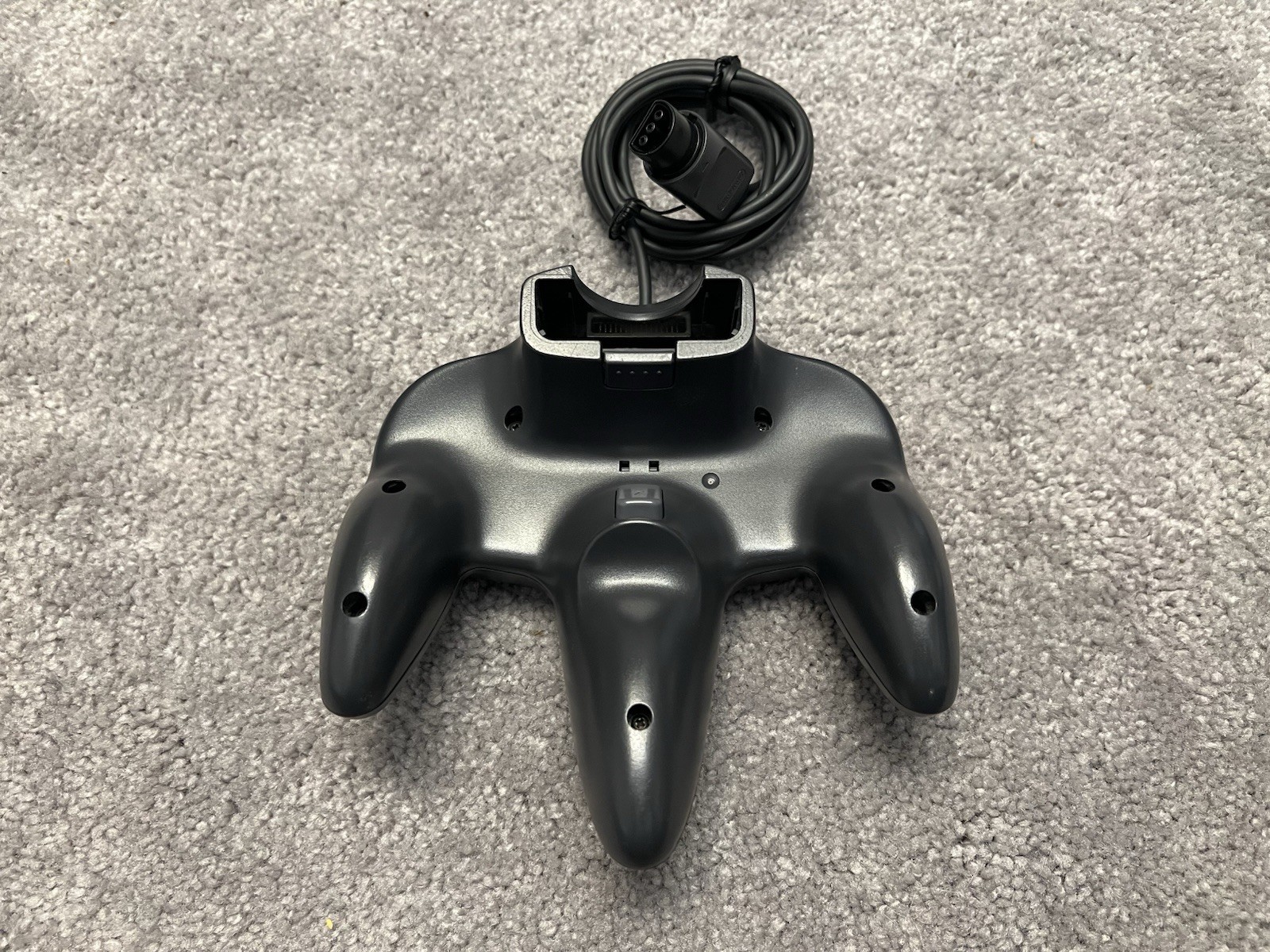Nintendo 64 with black controller, AV cables, and power supply.