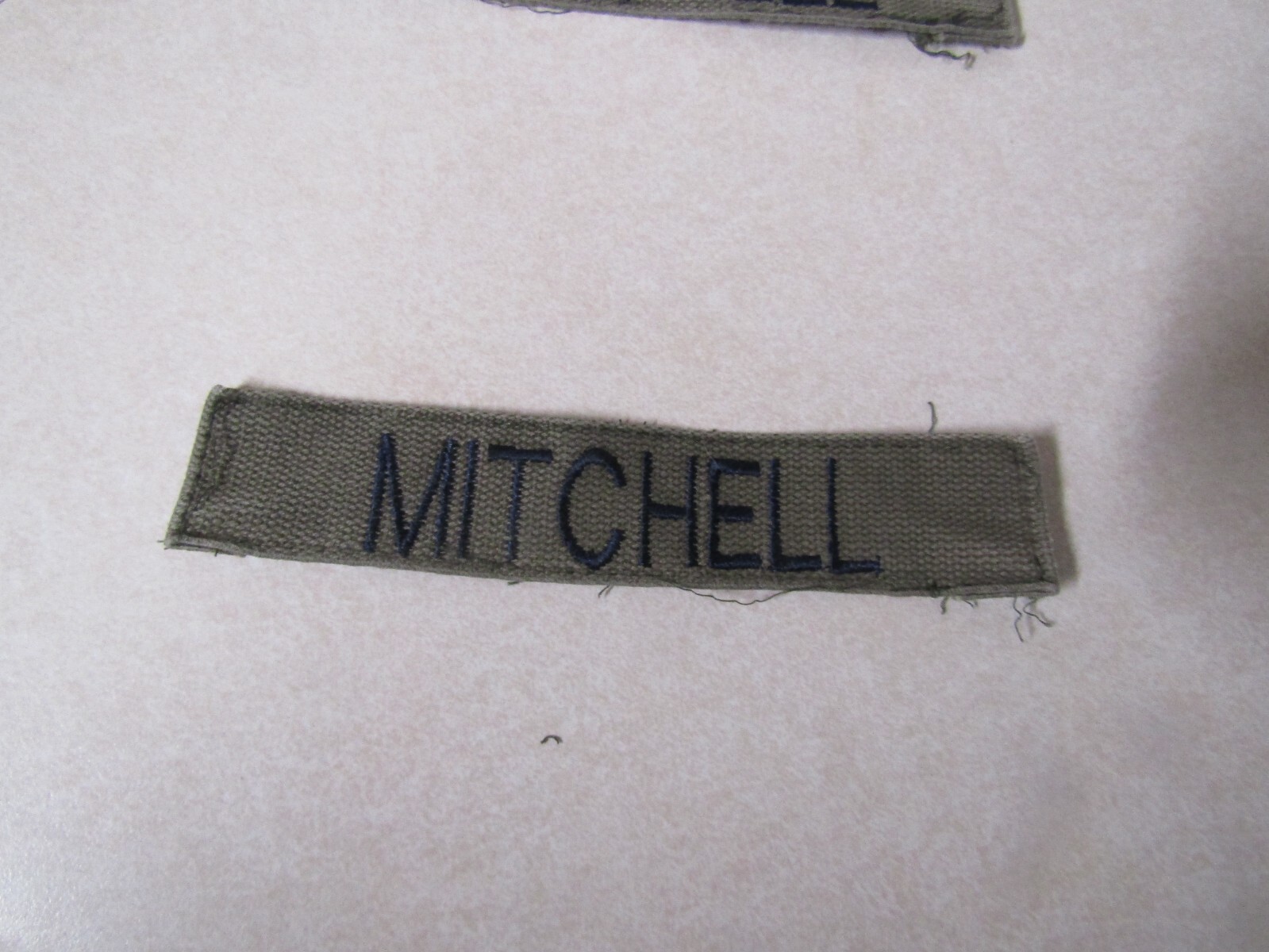 MILITARY PATCH OLDER COMBAT USED NAME TAPE OD GREEN SEW ON MITCHELL BLUE LETTERS