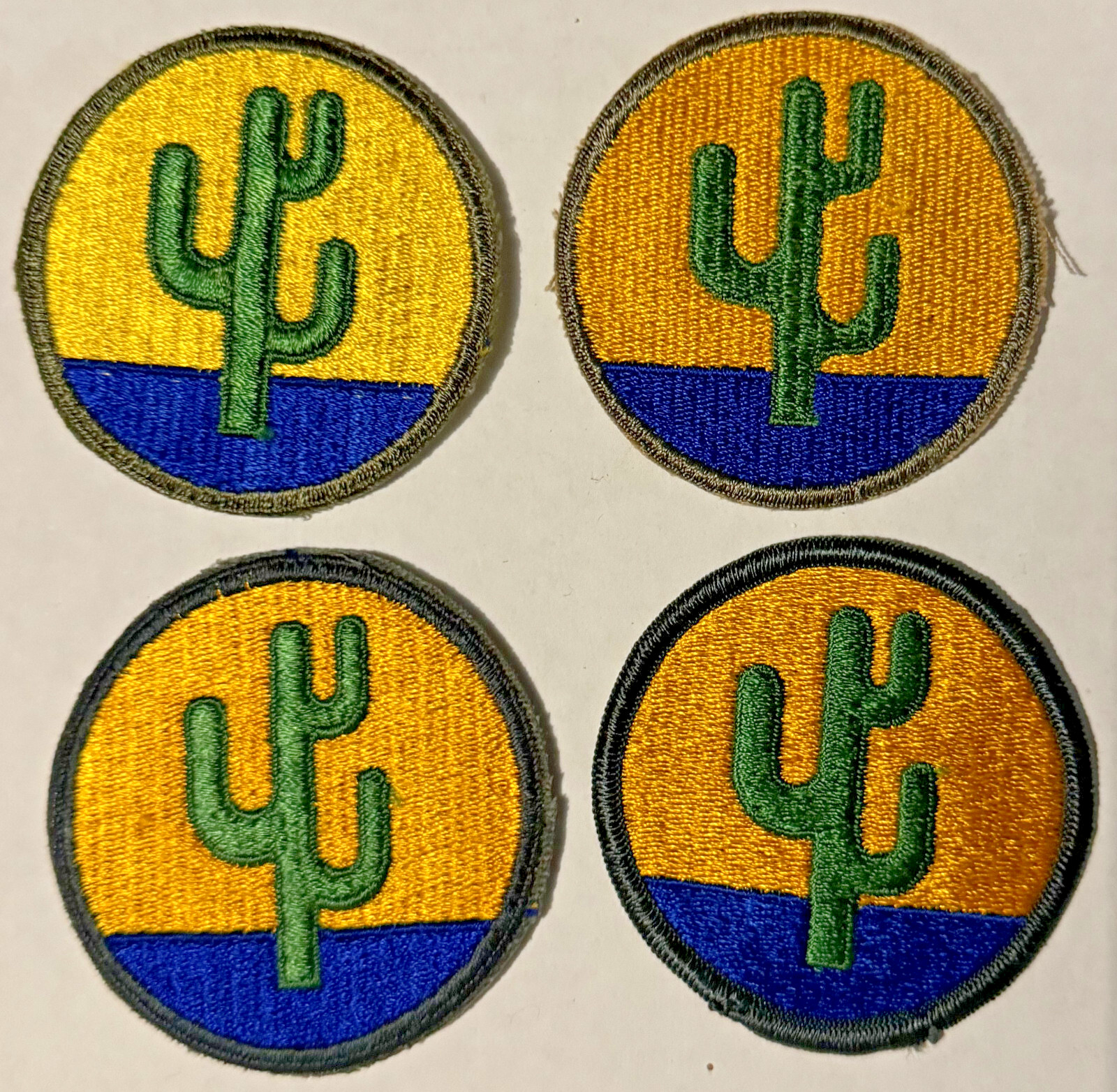 Collection of four 103rd Division SSI Patches Including Pre-War Lemon Yellow Sky