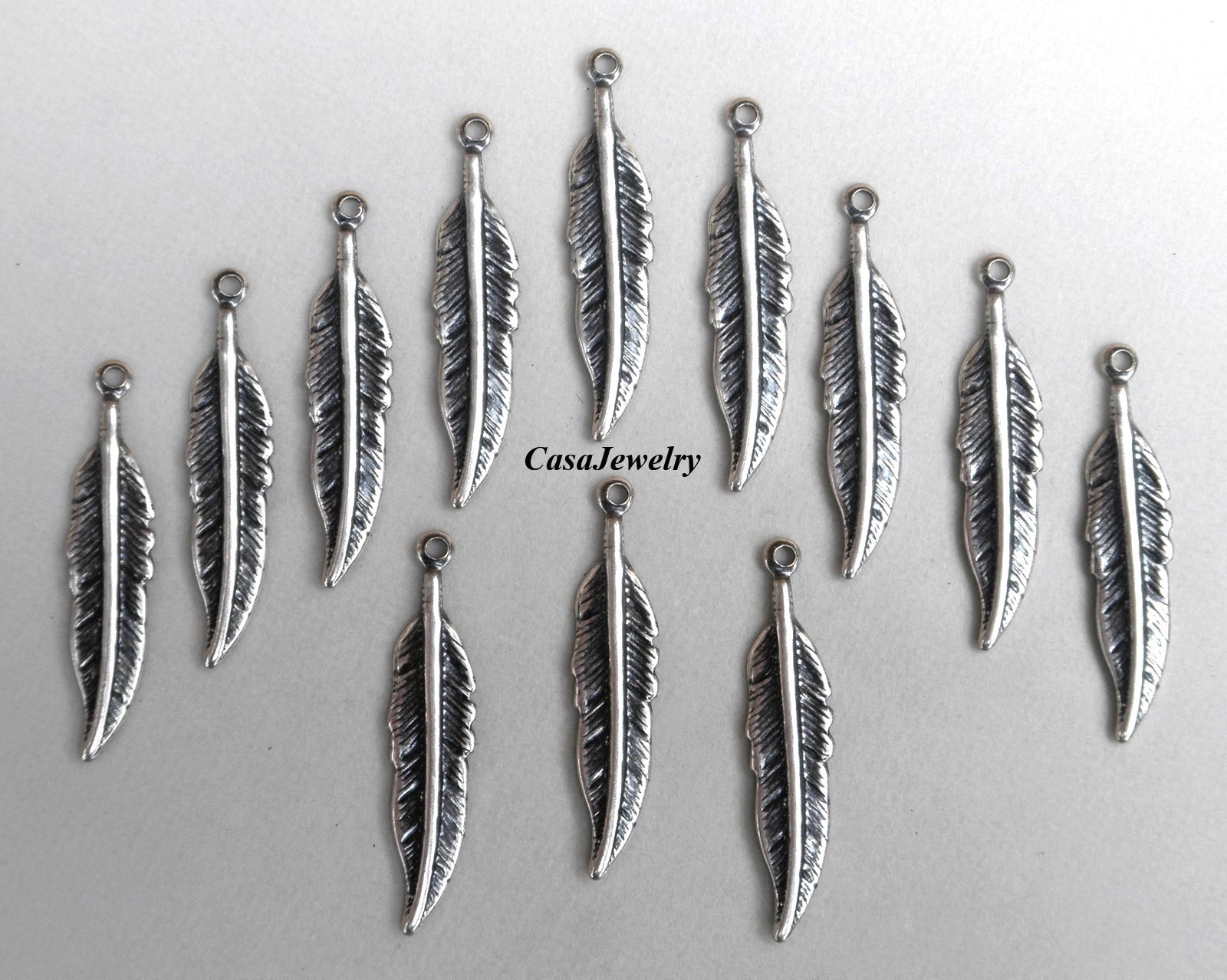 #1147 SMALL ANTIQUED .925 STERLING SILVER PLATED FEATHER W/HANG RING - 12 Pcs