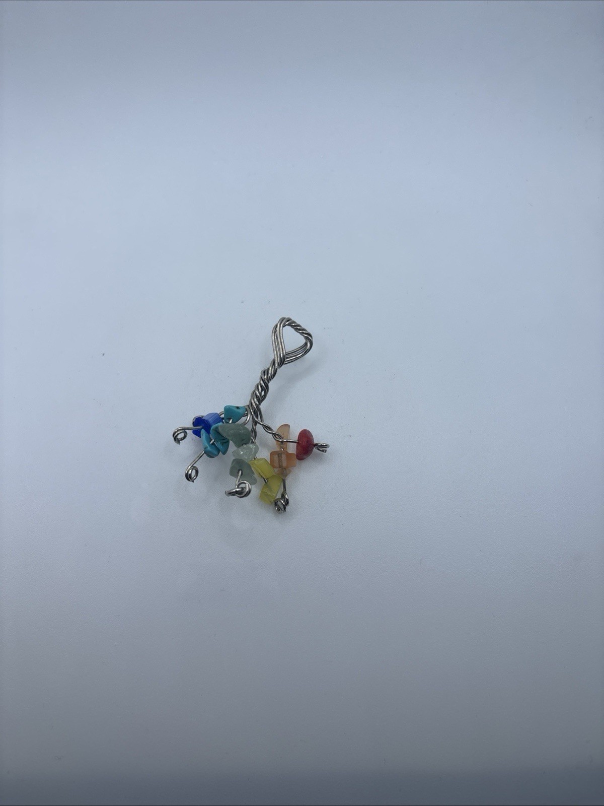 This is a handmade wire-wrapped keychain featuring multicolored gemstone chip