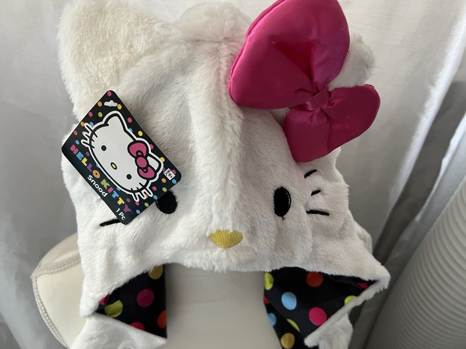 Hello Kitty Hat Hood in white with a pink bow and a polka dot lining.