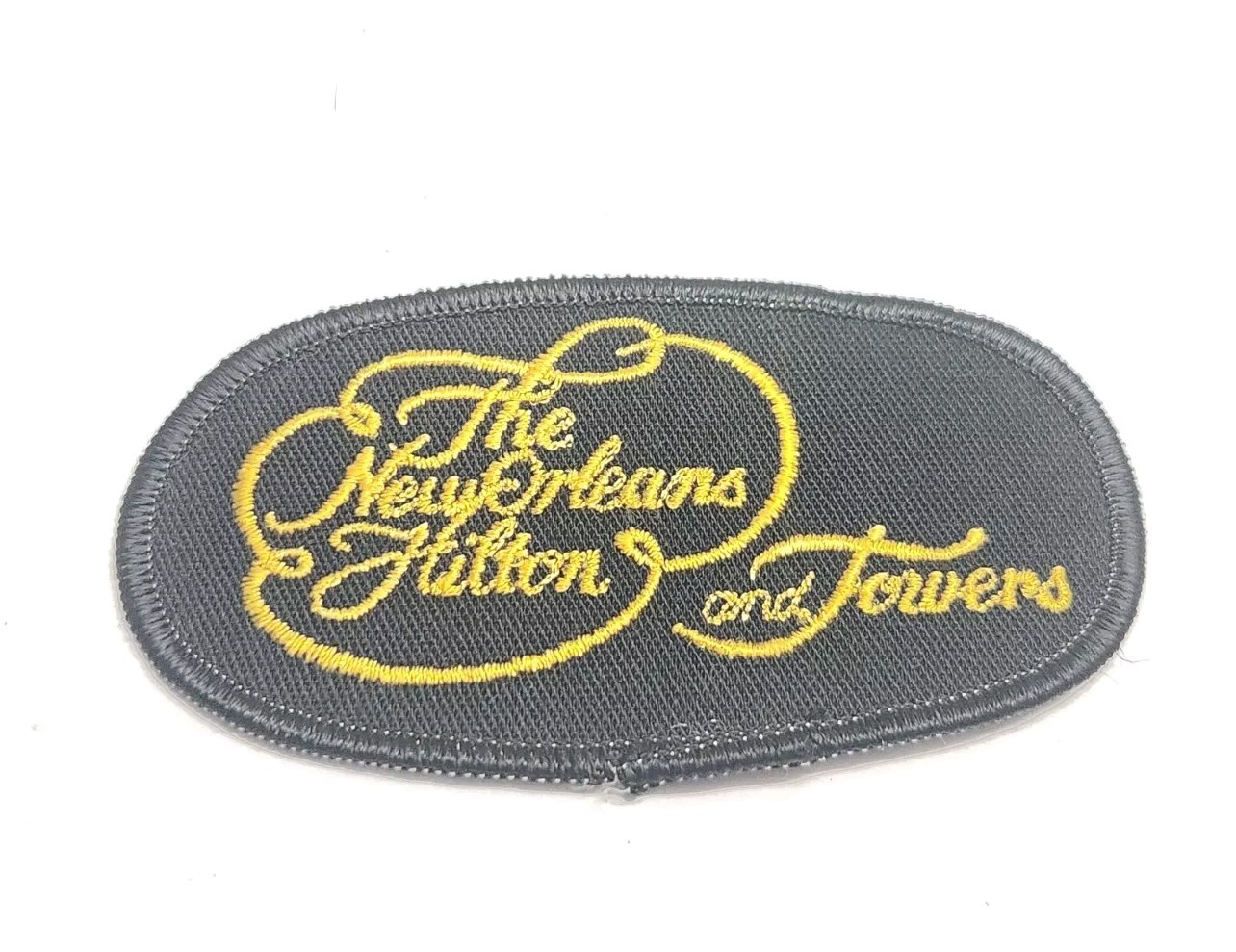 The New Orleans Hilton and Towers Vintage Employee Uniform Logo Black Gold Patch