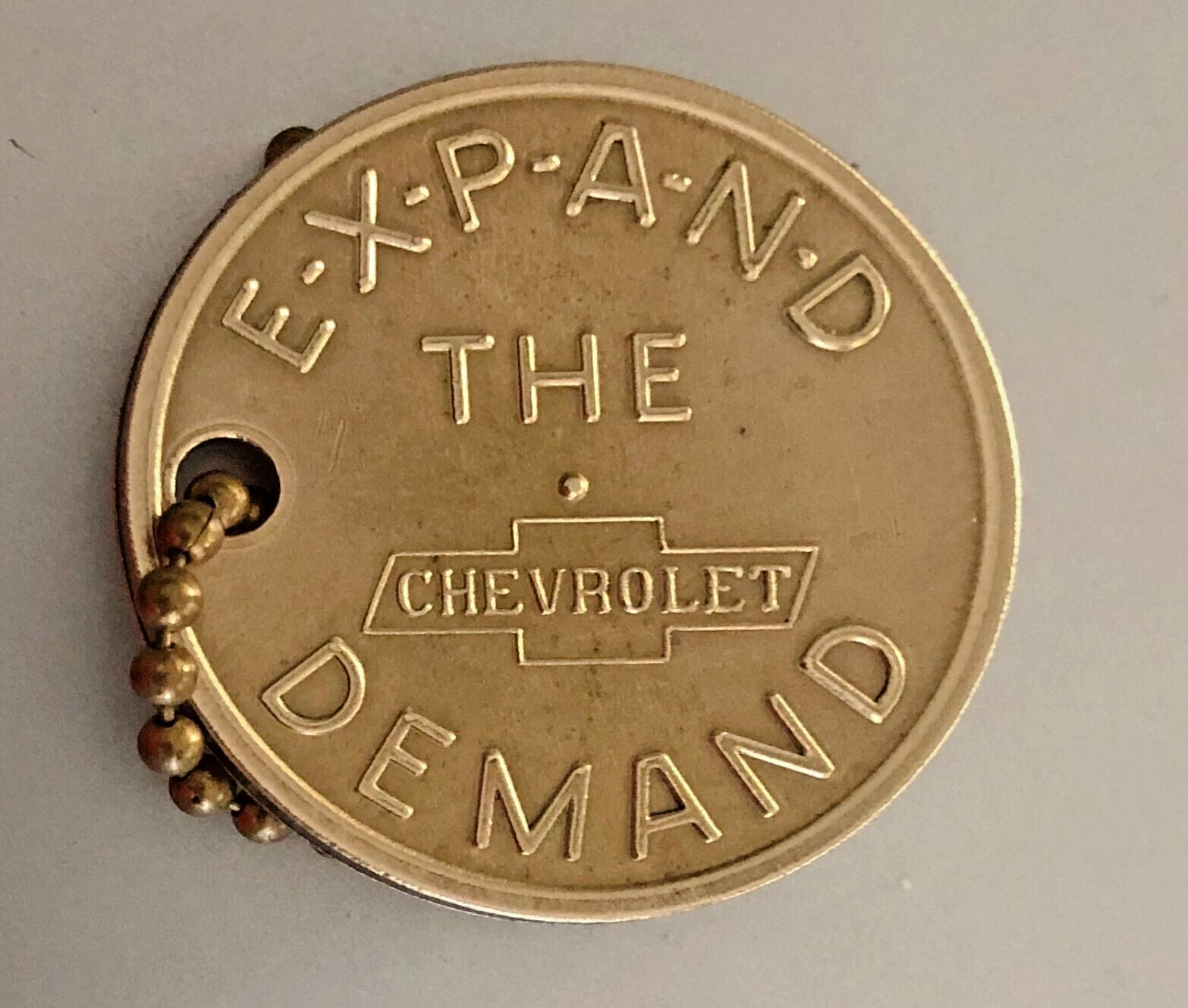 Vtg CHEVROLET Brass Key Fob or Spinner Token: EXPAND THE DEMAND; YOU'RE THE MAN