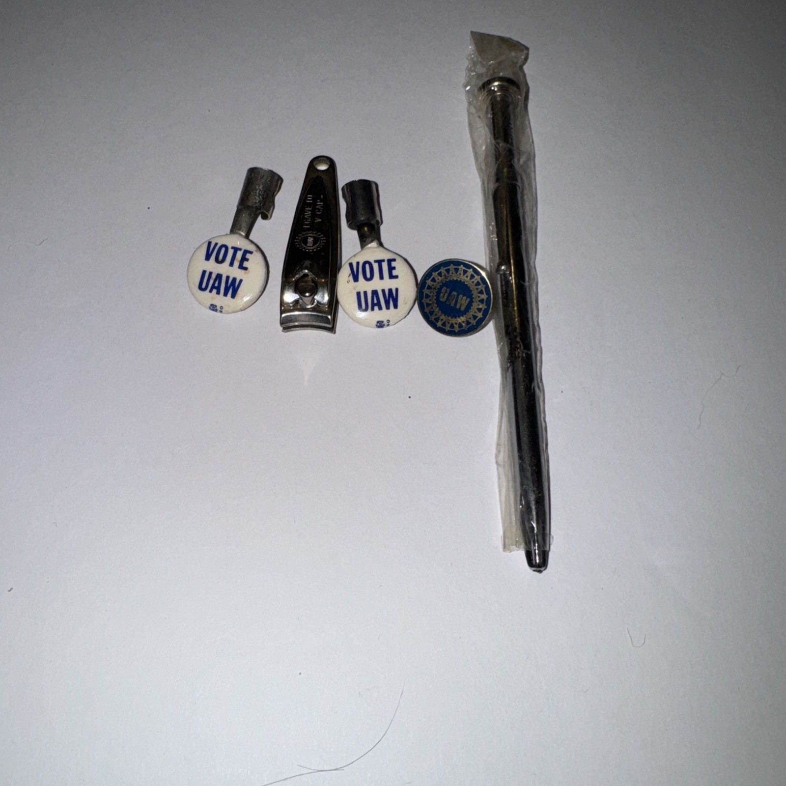 UAW Memorabilia Lot Of 5 Items. 1 nail clipper, 1 Ink Pen, 1 Pin, 2 UAW toppers