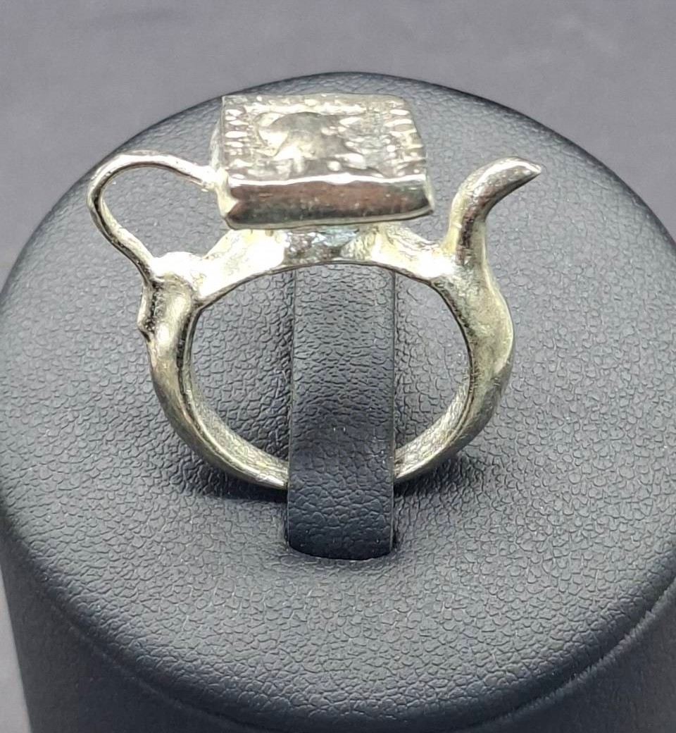 vintage-style ring featuring a square, textured face plate Roman Greco coin