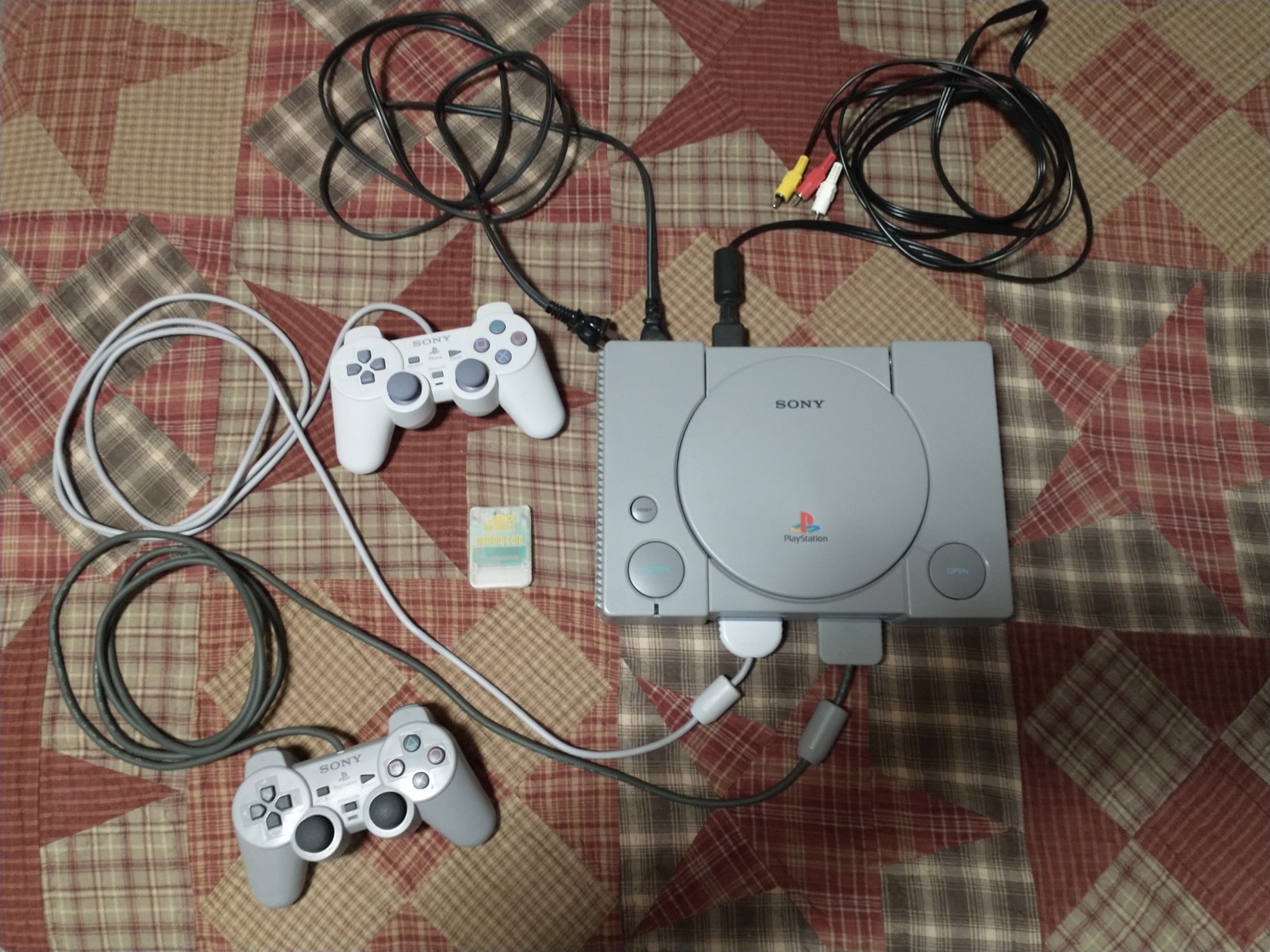 Sony Playstation 1 console w/ controllers, cords, memory card, & games