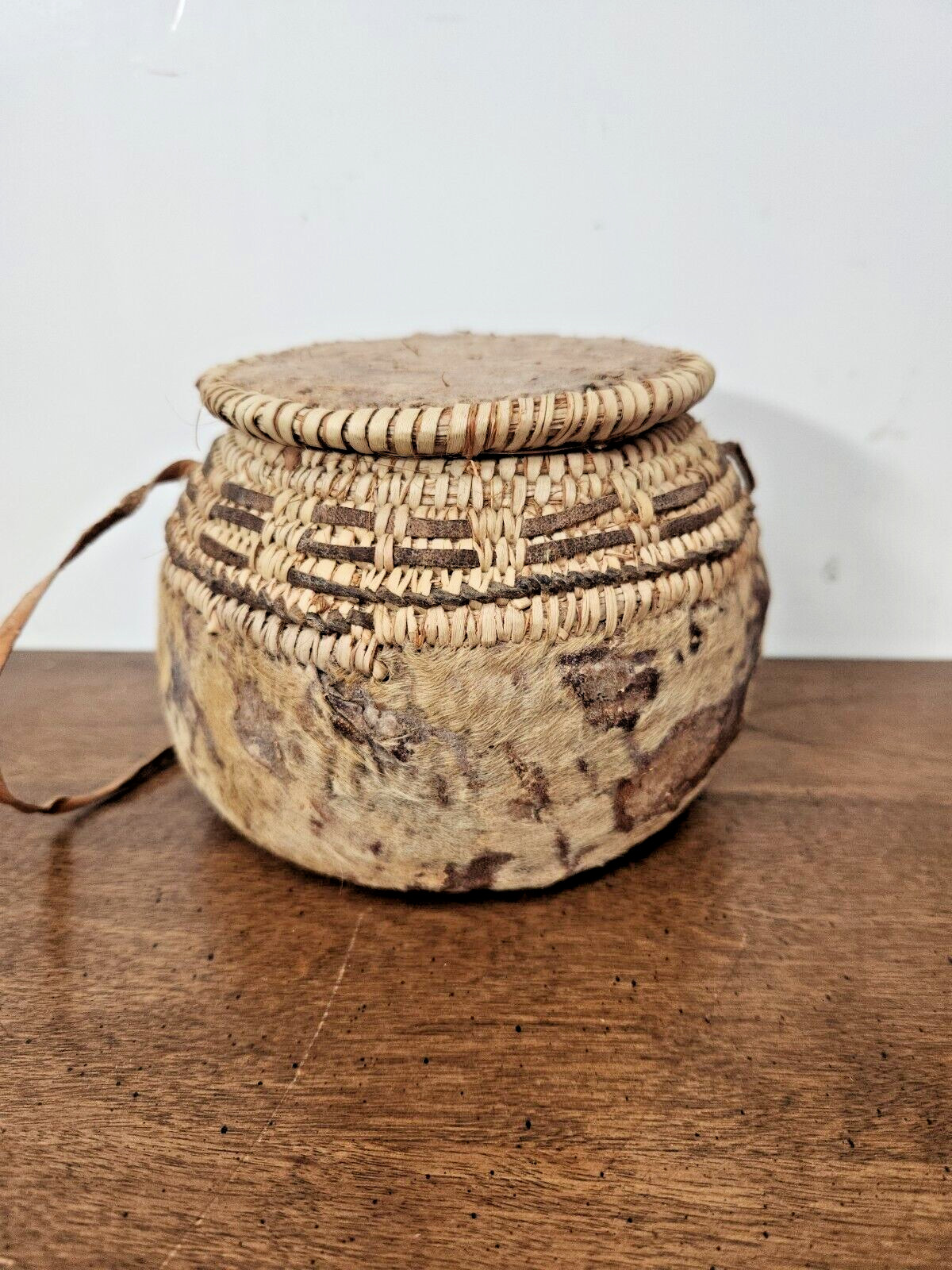 ANTIQUE OMANI BEDOUIN WOVEN LIDDED BASKET WITH LEATHER