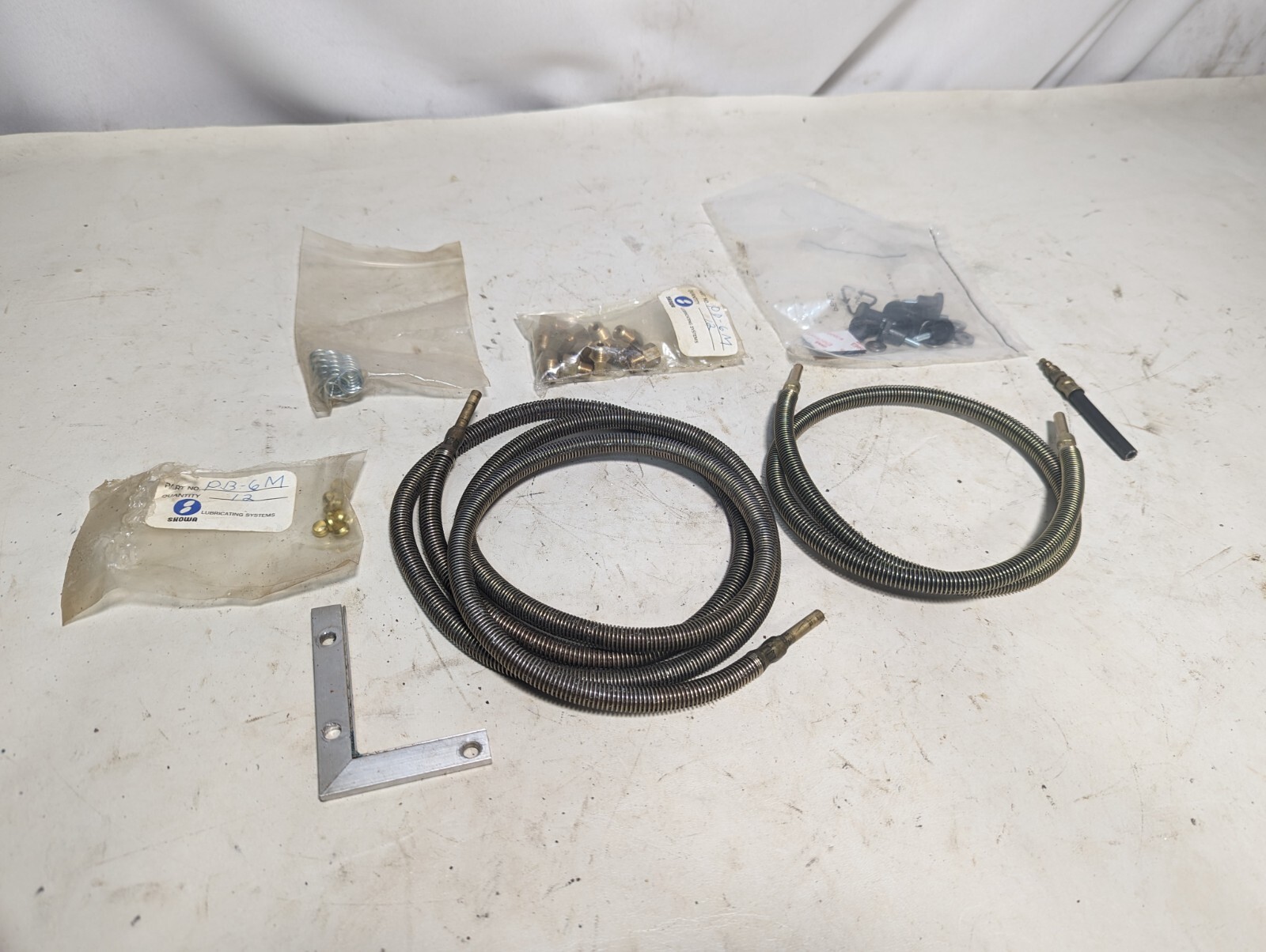 Lot of assorted Showa lubricating parts: two hoses, PB-6M, springs, PD-6M