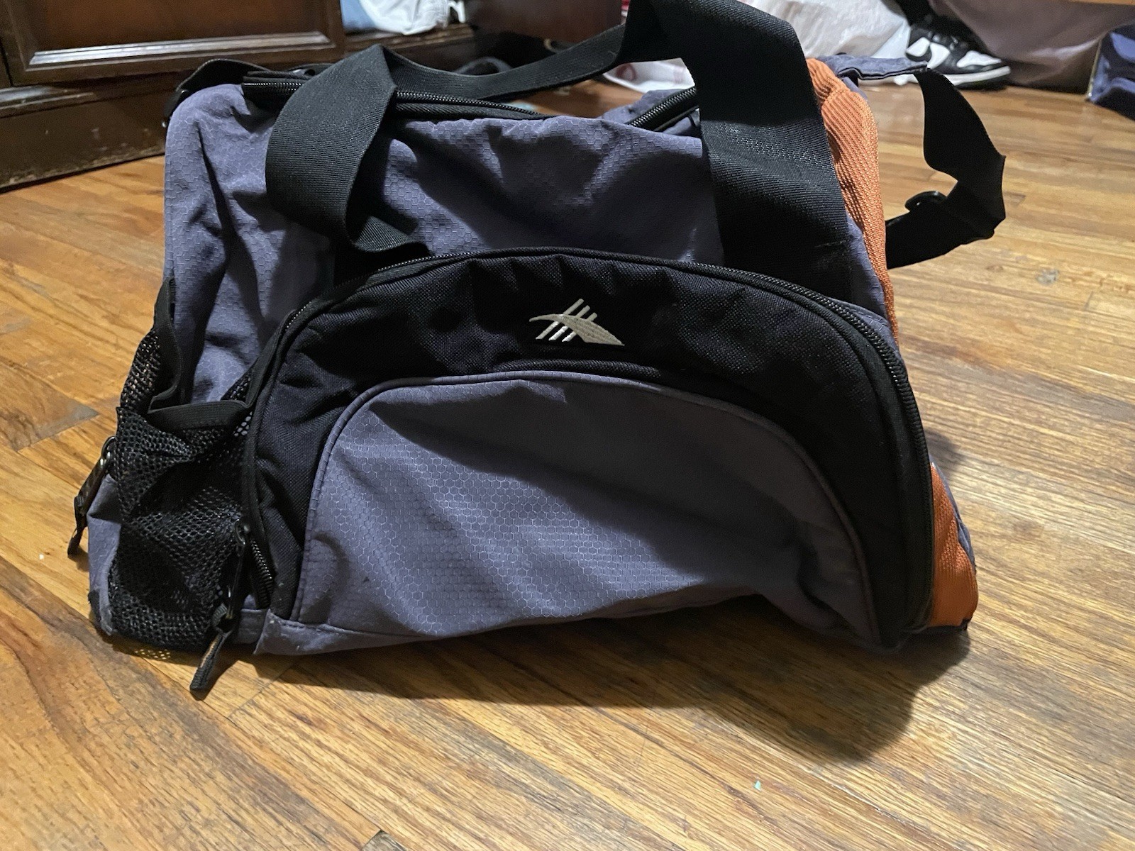 High Sierra Duffel Bag with Cross Body Attachment In Black with Orange Accents