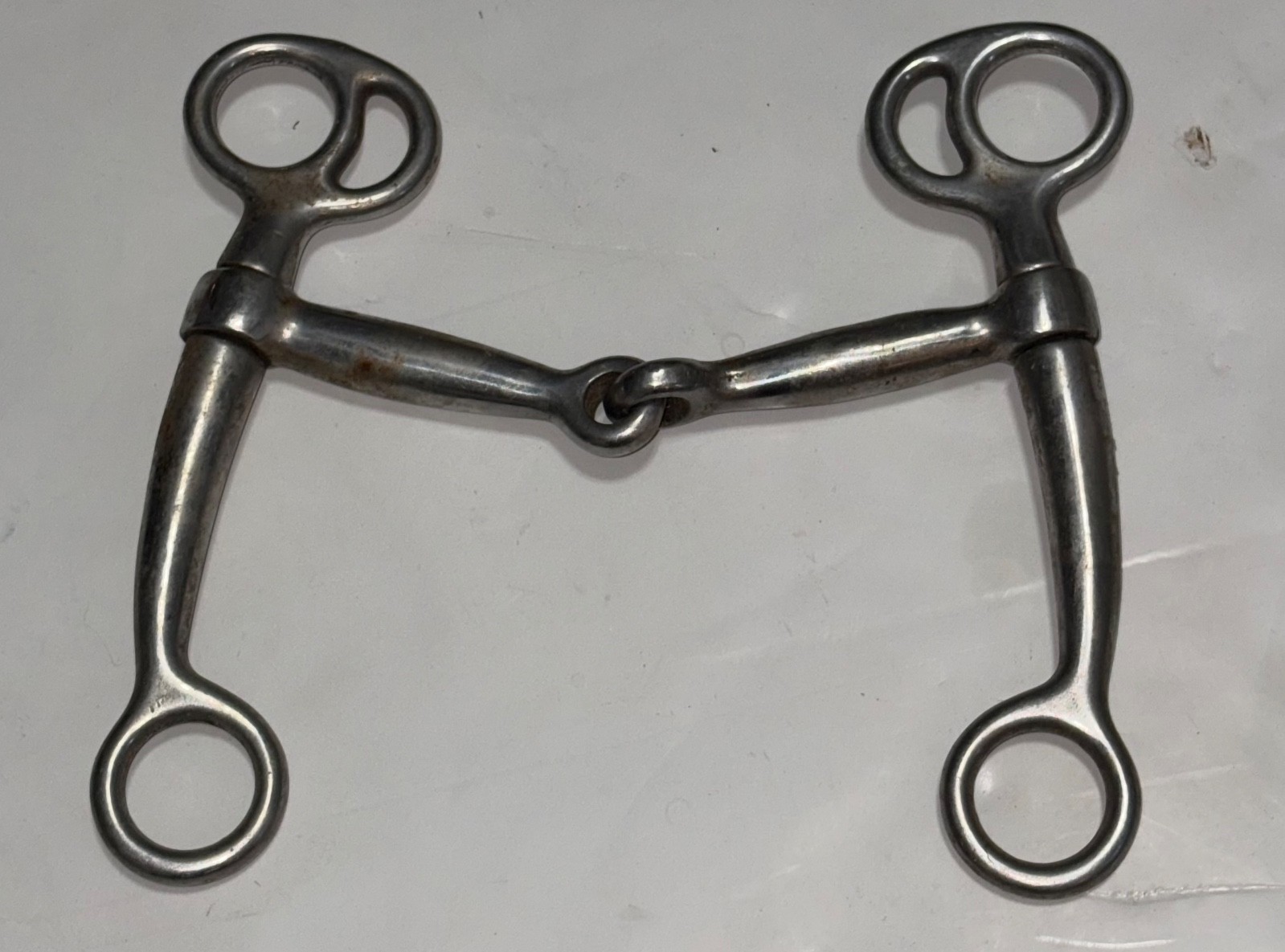 Used stainless steel Tom Thumb horse bit with a single-jointed mouthpiece
