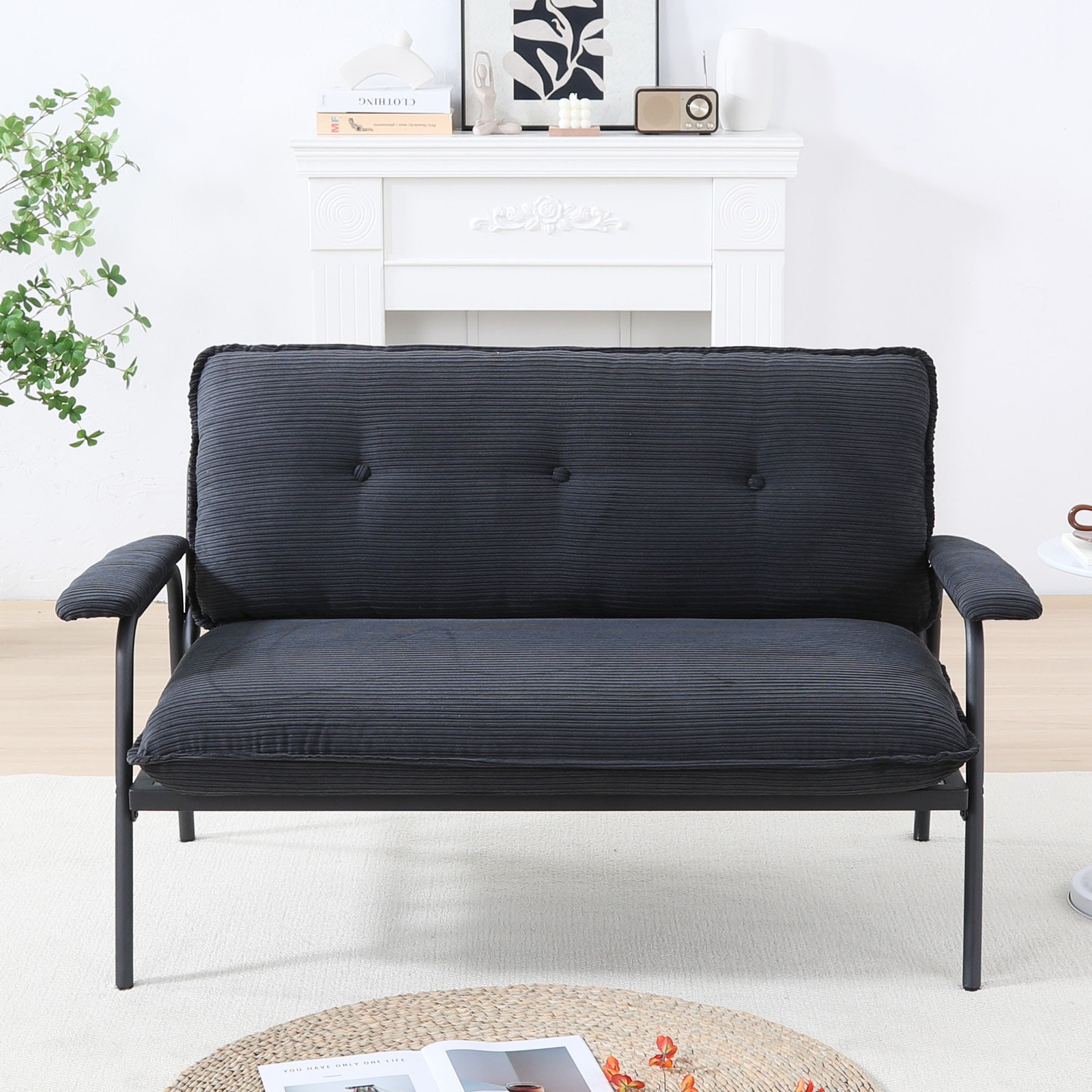 The 53-inch black sofa offers a spacious layout in the small apartment, easily