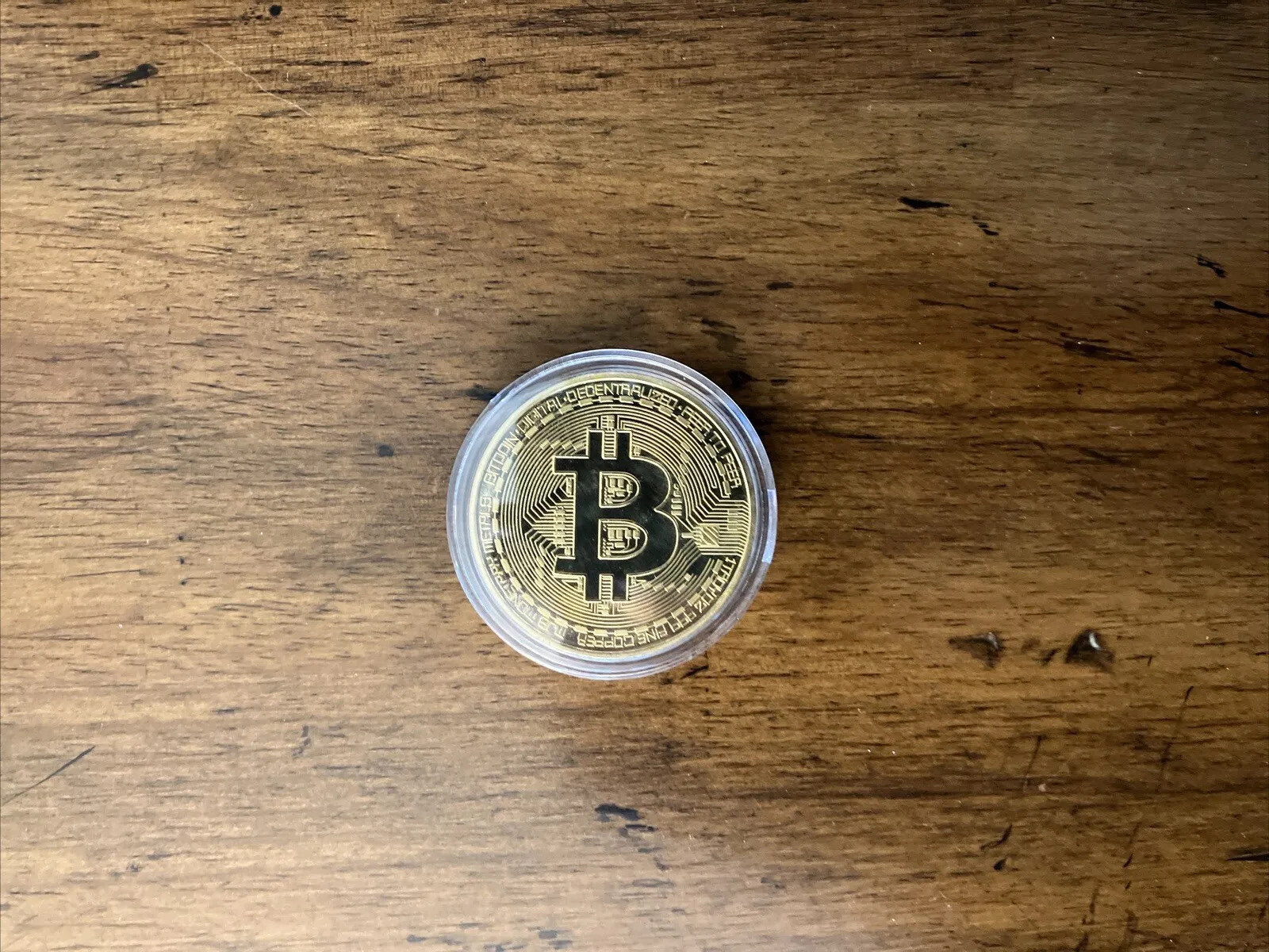 Bitcoin - gold colored Bitcoin in protective case.