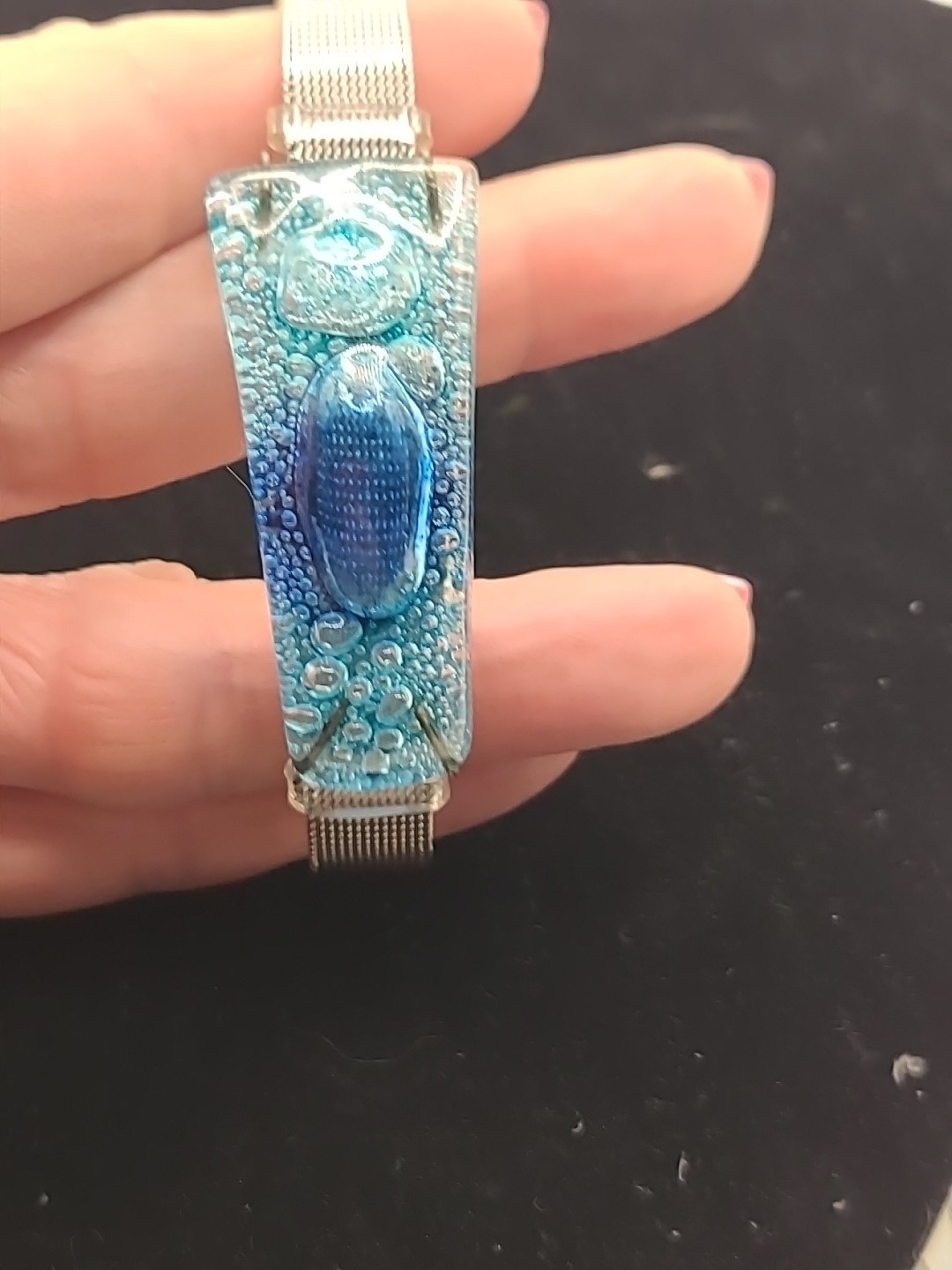 Bracelet silver band with blue fused art glass piece.