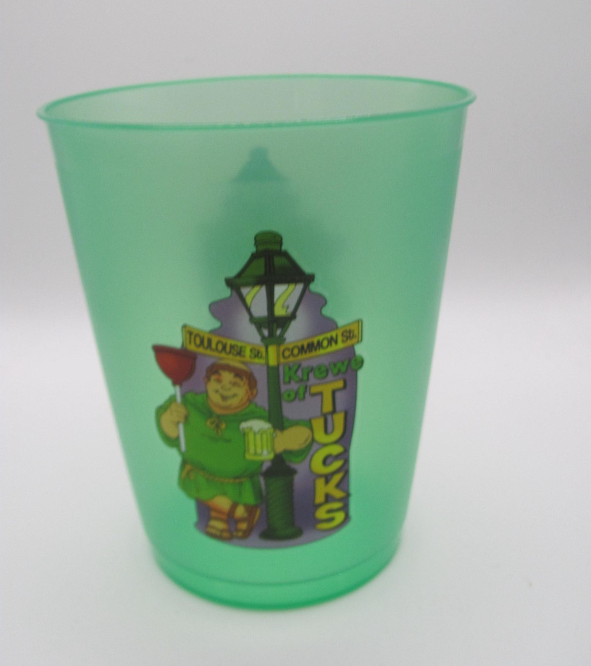 KREWE OF TUCKS GREEN PLASTIC REUSABLE CUP W/ FRIAR TUCK LEANING ON A STREET SIGN