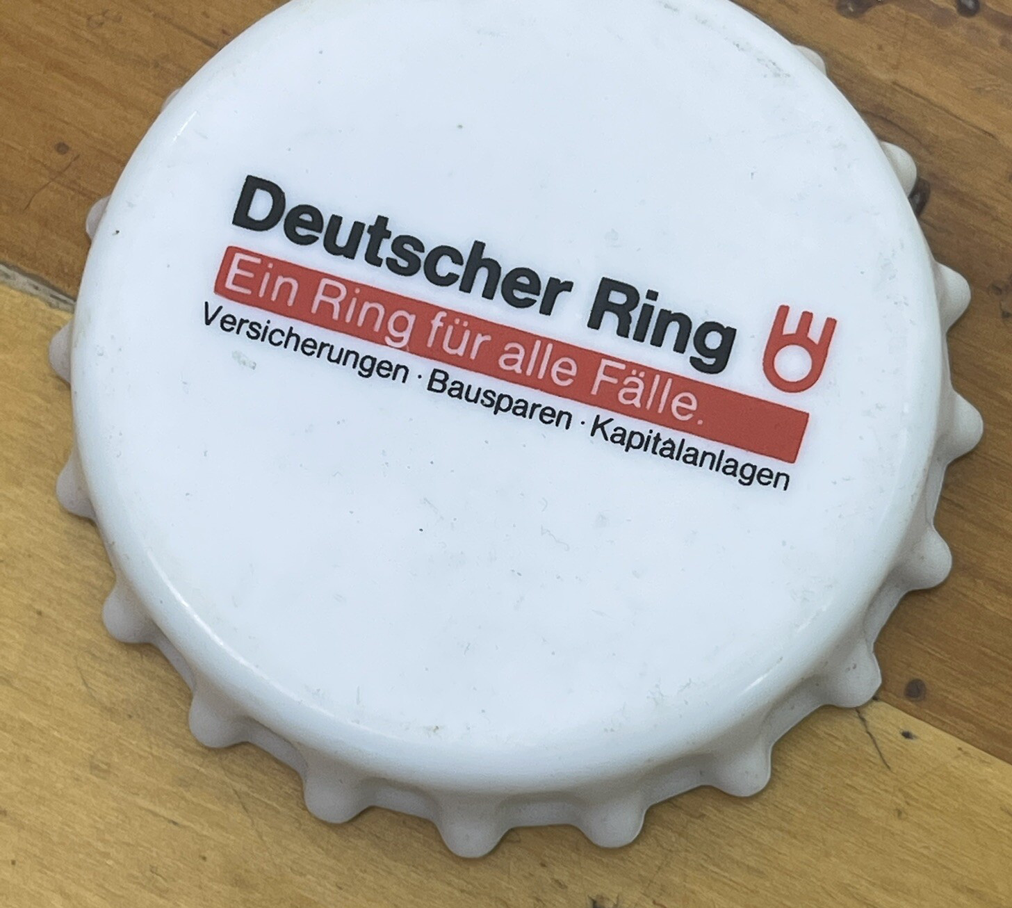 Large 3" White Plastic Bottle Cap Shaped Opener German Ad for Insurance