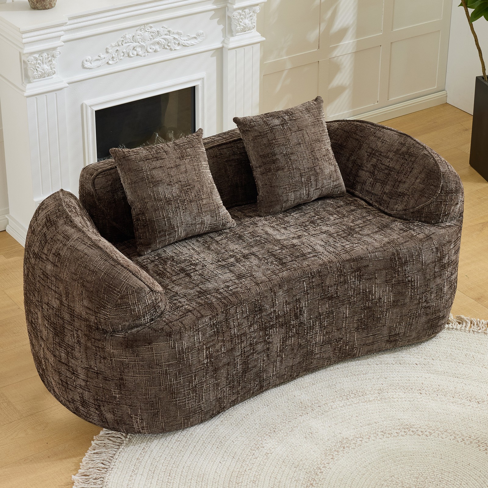 Brown curved two - person compress  sofa. It has armrests on both sides, comes w