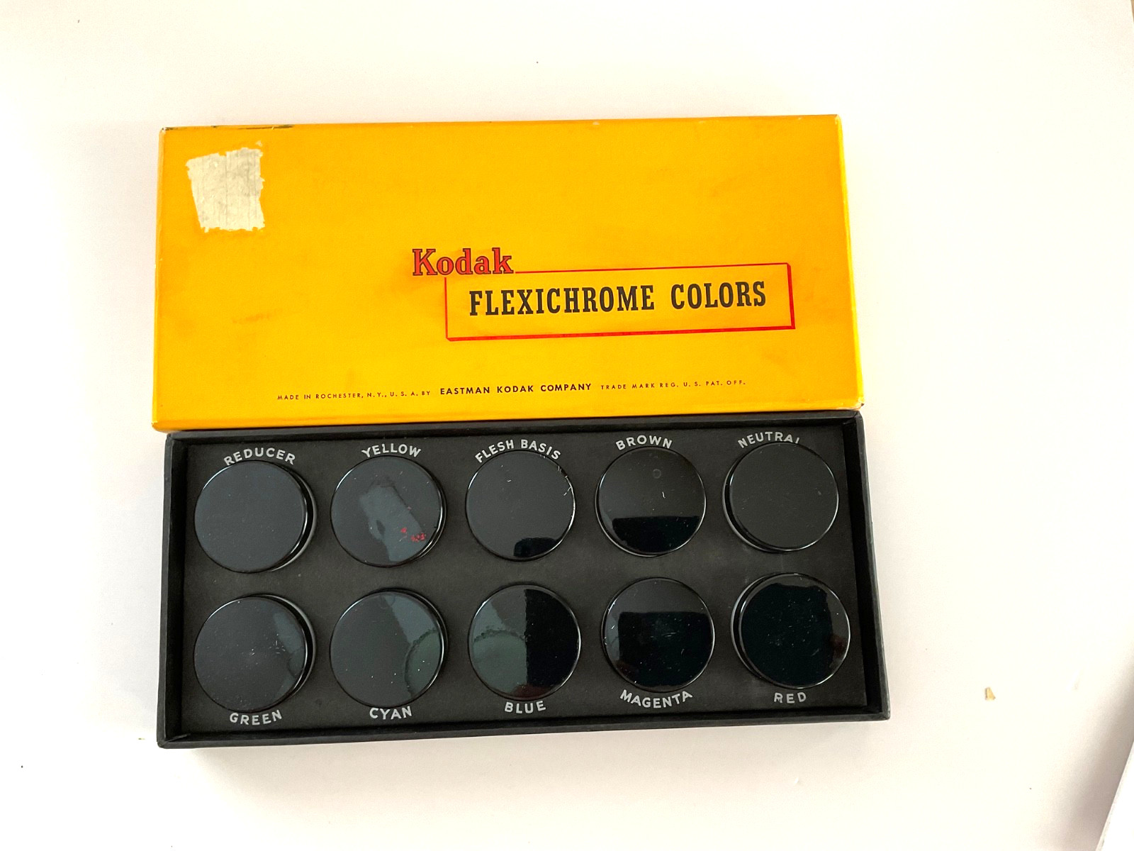 Vintage Kodak flexichrome set of 10 jars, different colors, used in photography.