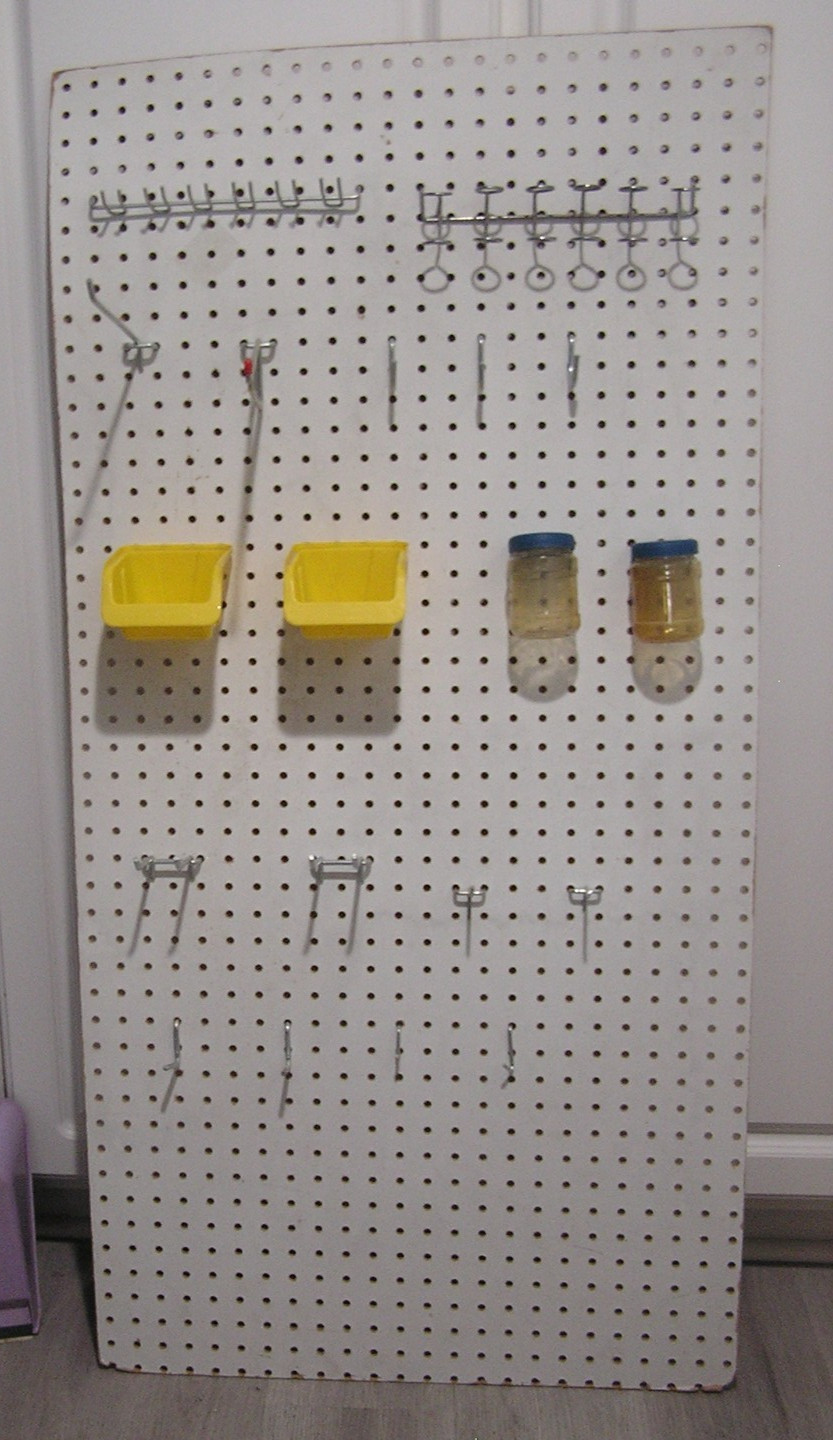 Composite Pegboard with Hooks and Bins Moounted