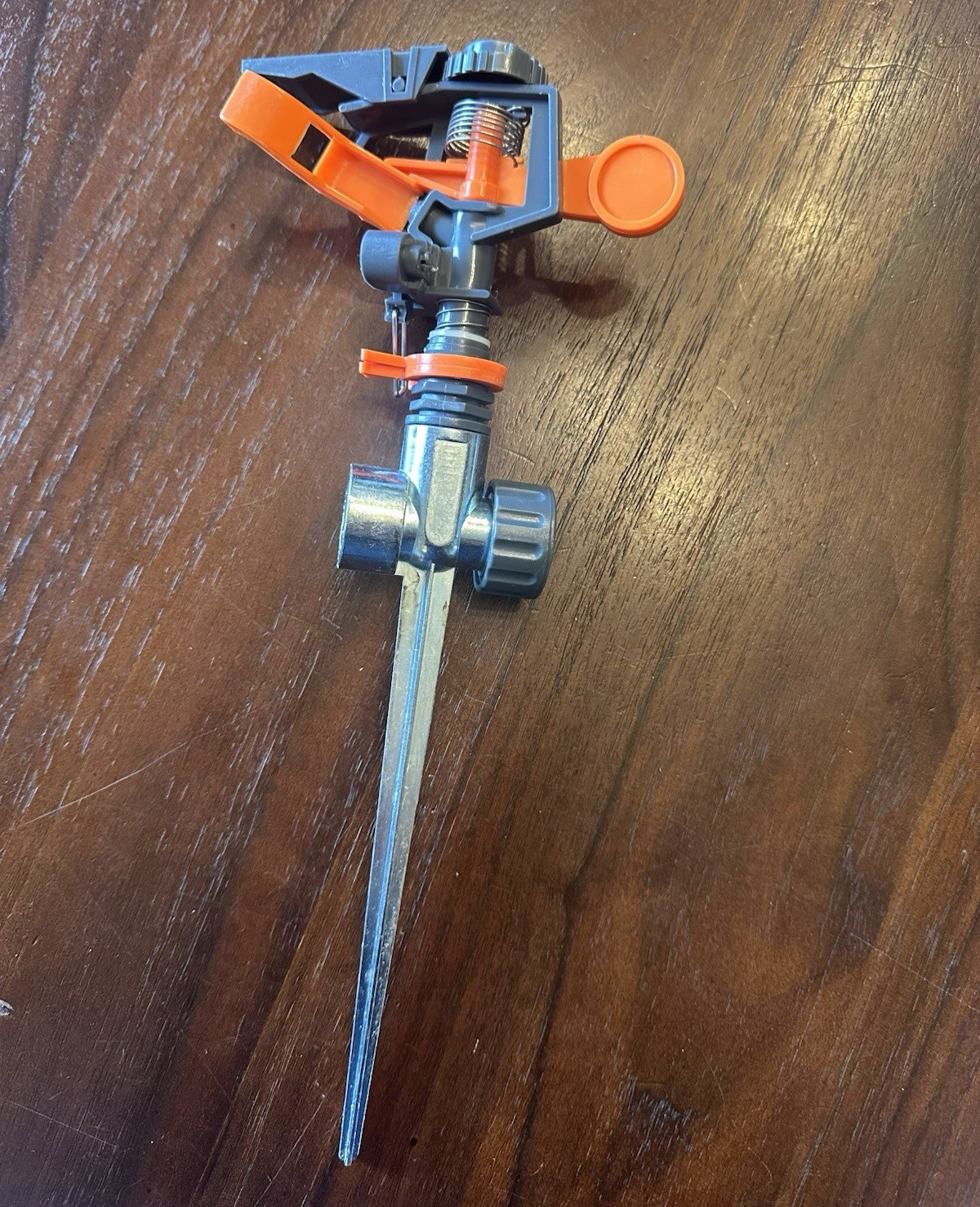 Gray/Orange Lawn Irrigation Sprinkler on Metal Spike, Adjustable Spray