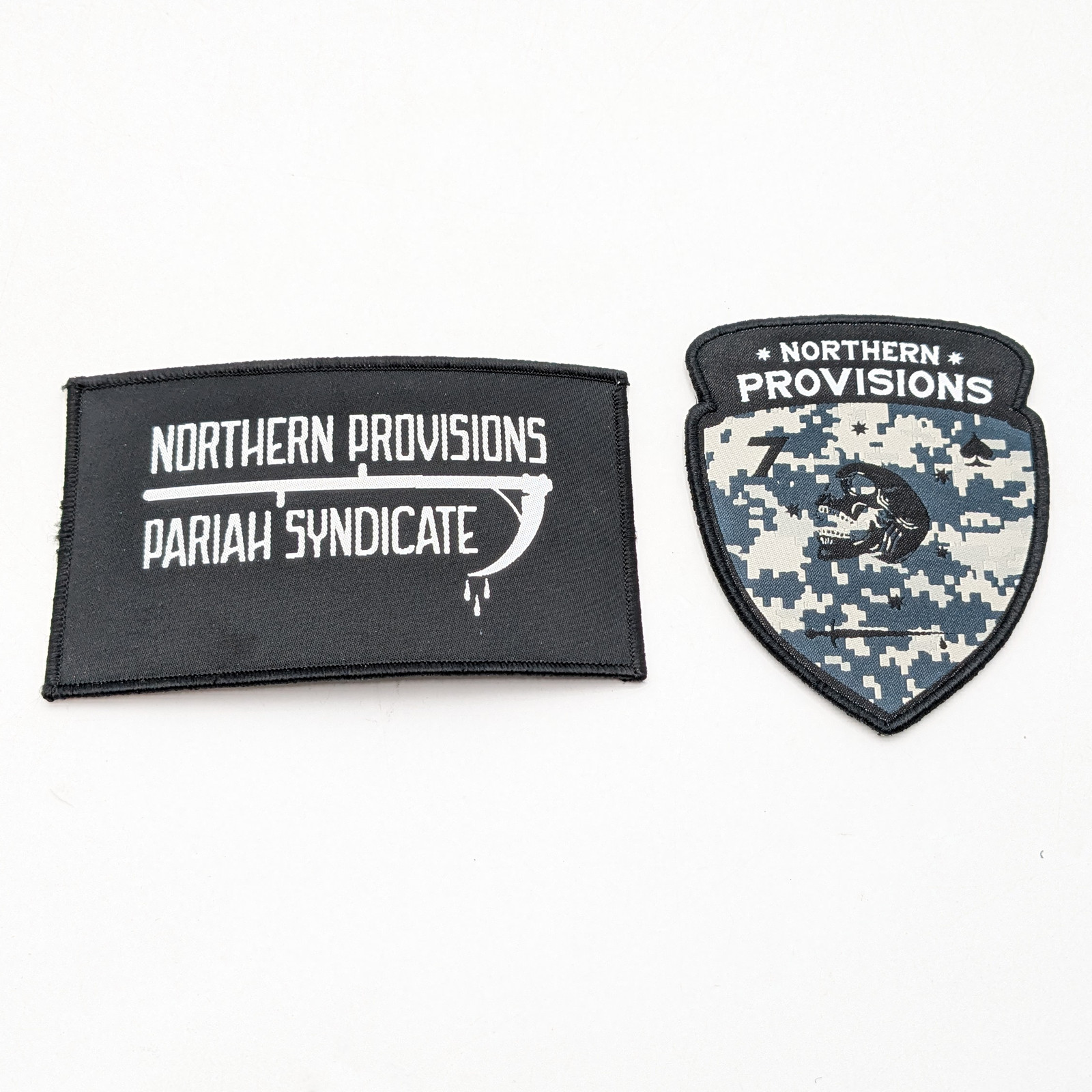 Assorted Northern Provisions Collectible Patches In Camoflauge & Black Lot of 2