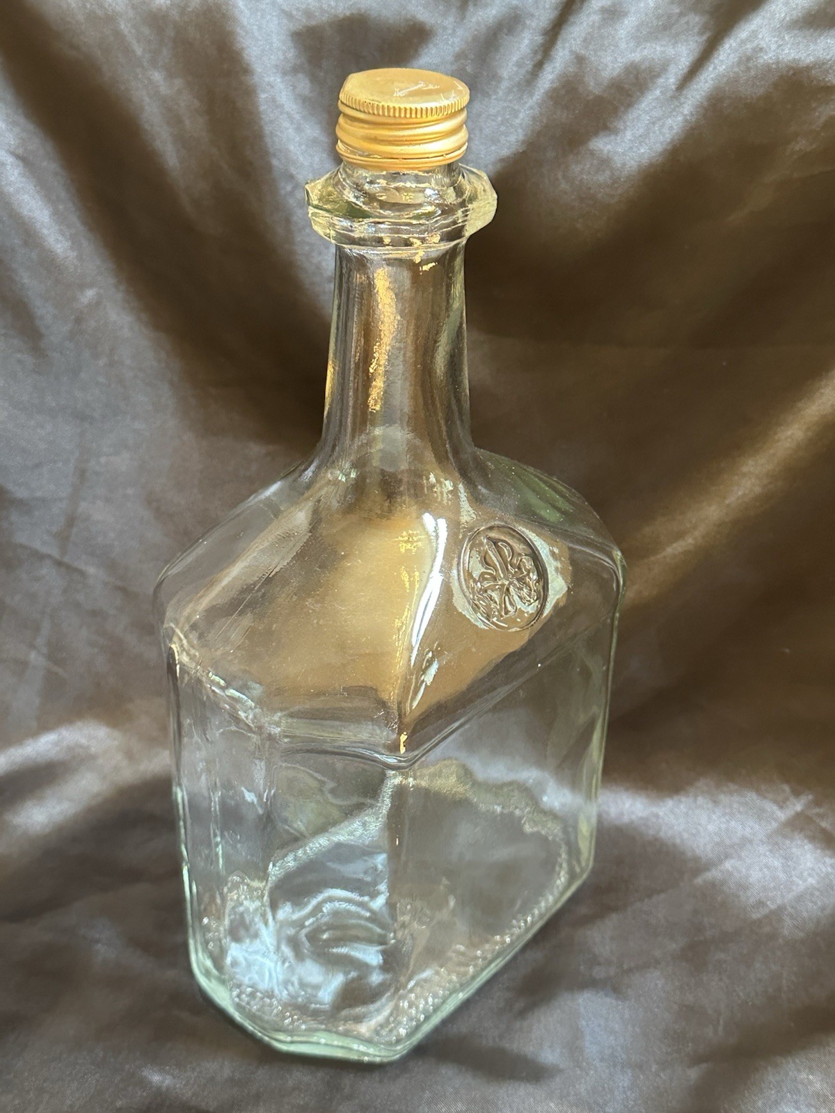 Vintage 1974 Clear Glass Liquor Bottle Gold Screw Cap Embossed Trefoil Design