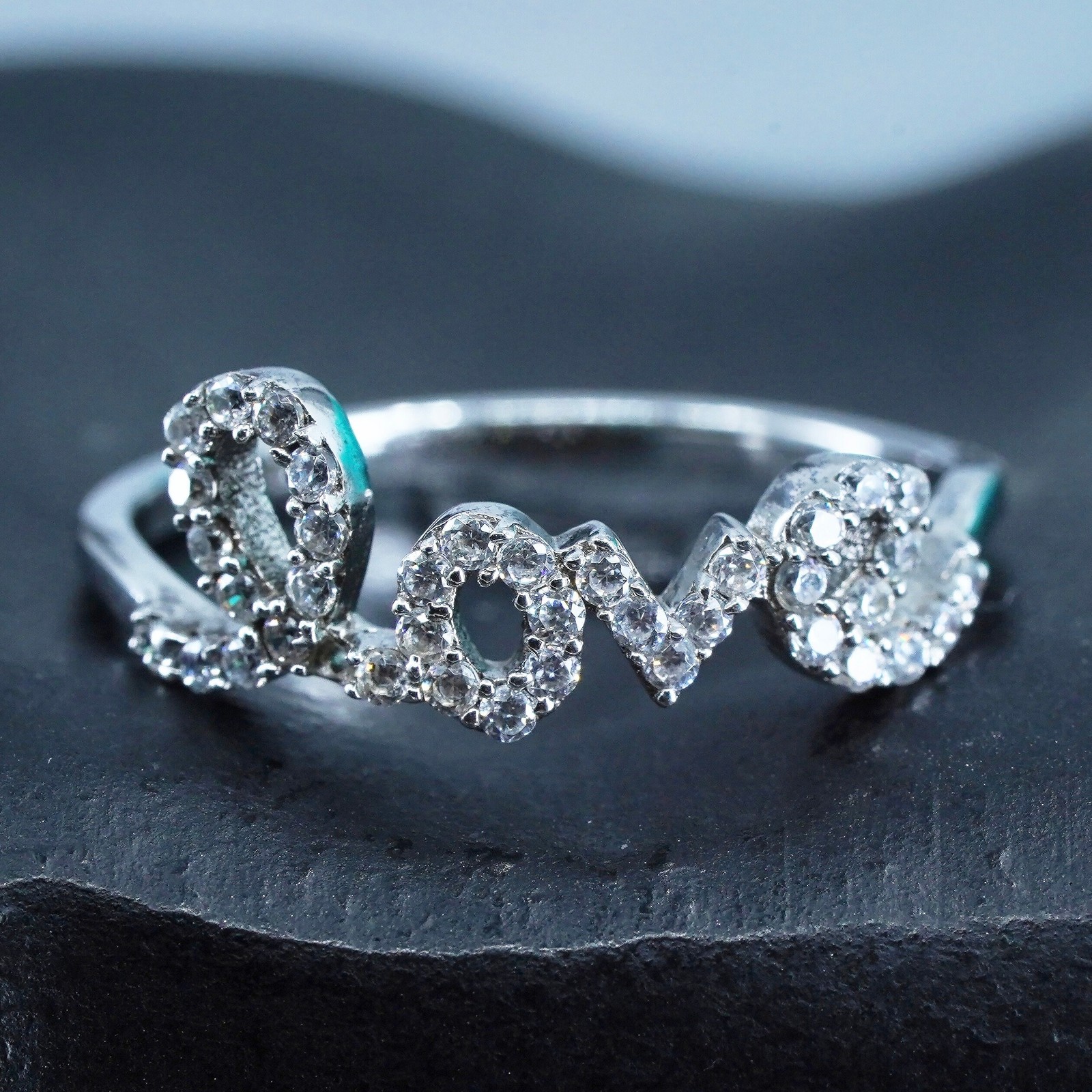 Size 8, southwestern Sterling 925 silver wedding ring, band with “love” and cz