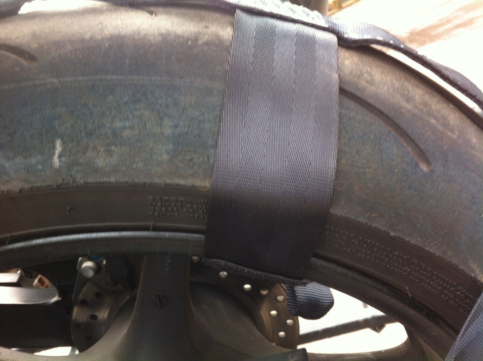 Rear wheel tie-down strap