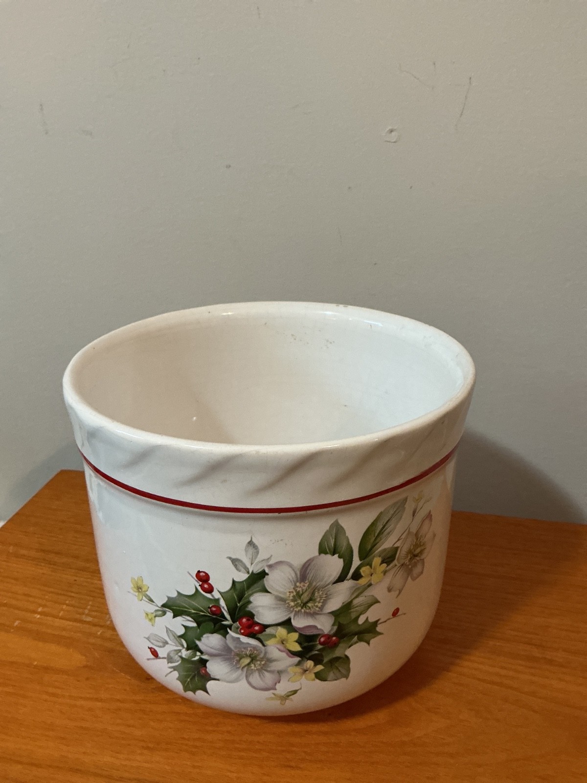 vintage white ceramic planter pot decorated with a floral and berry pattern.