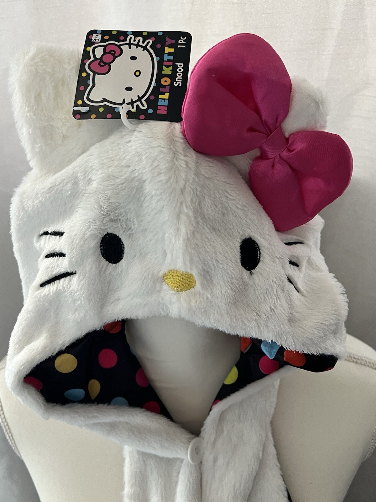 Hello Kitty Hat Hood in white with a pink bow and a polka dot lining.
