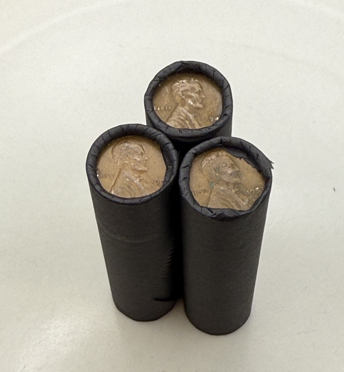 Tightly crimped black wheat penny bank rolls old unsearched coins cent us