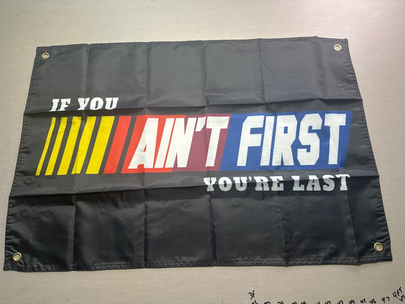 If You Ain't First You're Last 2x3 Banner, one sided, grommets both sides.