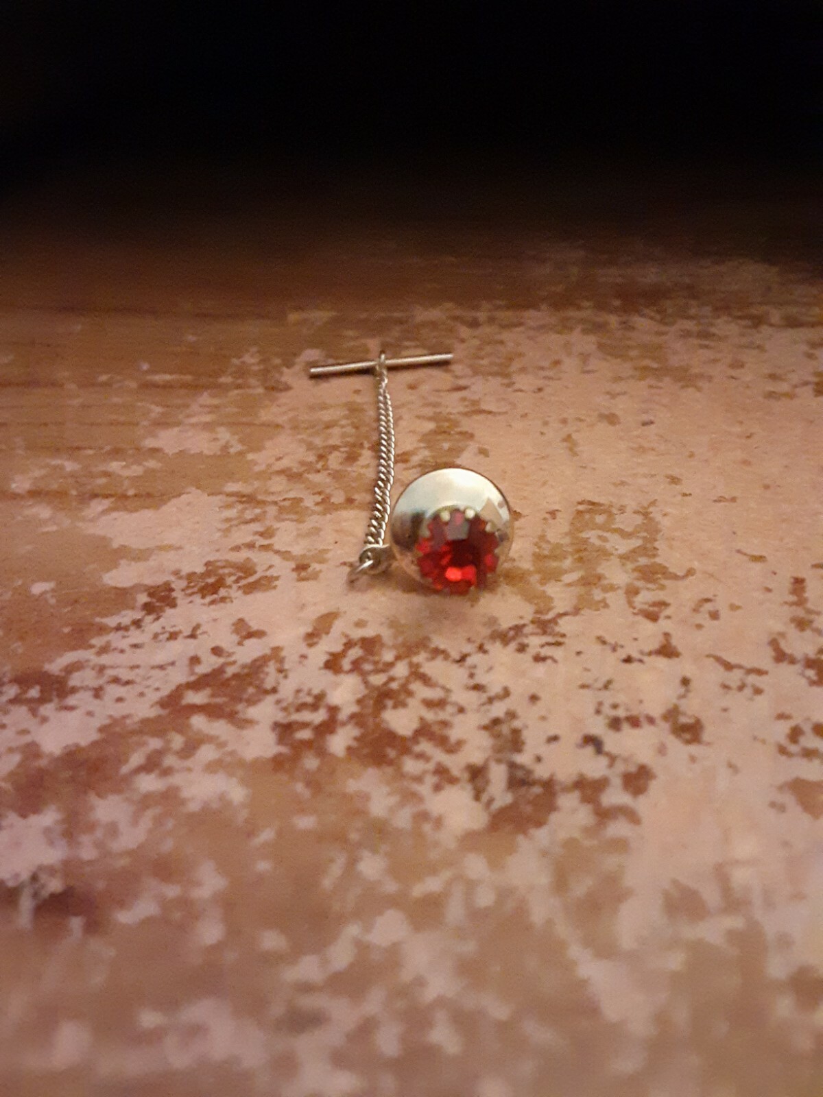 Used tie pin with a red stone in gold setting