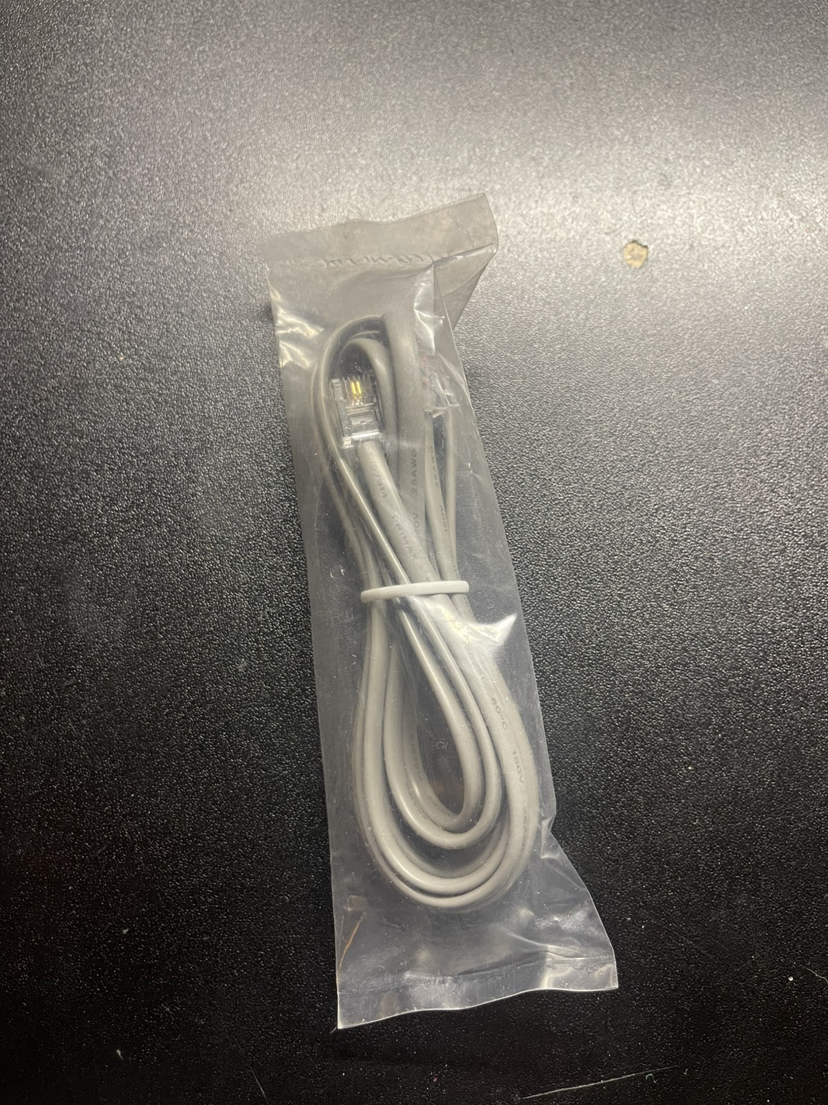 gray RJ11 cable, commonly used for connecting telephones or modems (B7)