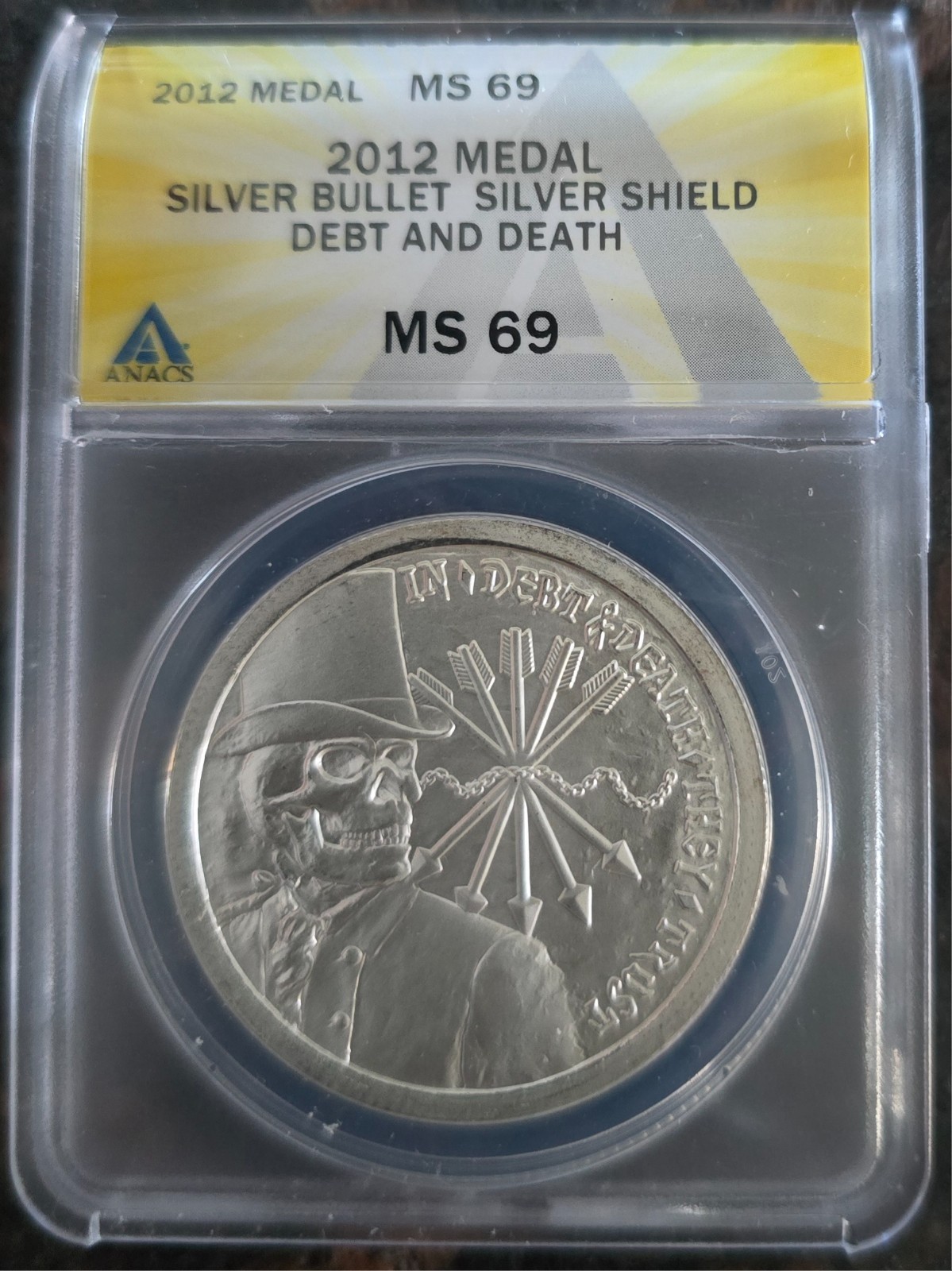 2012 Silver 1 oz DEBT & DEATH BU BU Reverse - SBSS - ANACS MS 69