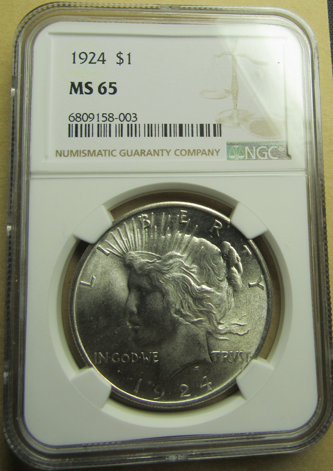 1924  NGC MS65 Peace Silver Dollar, Amazing Strike and Patina, Near White.
