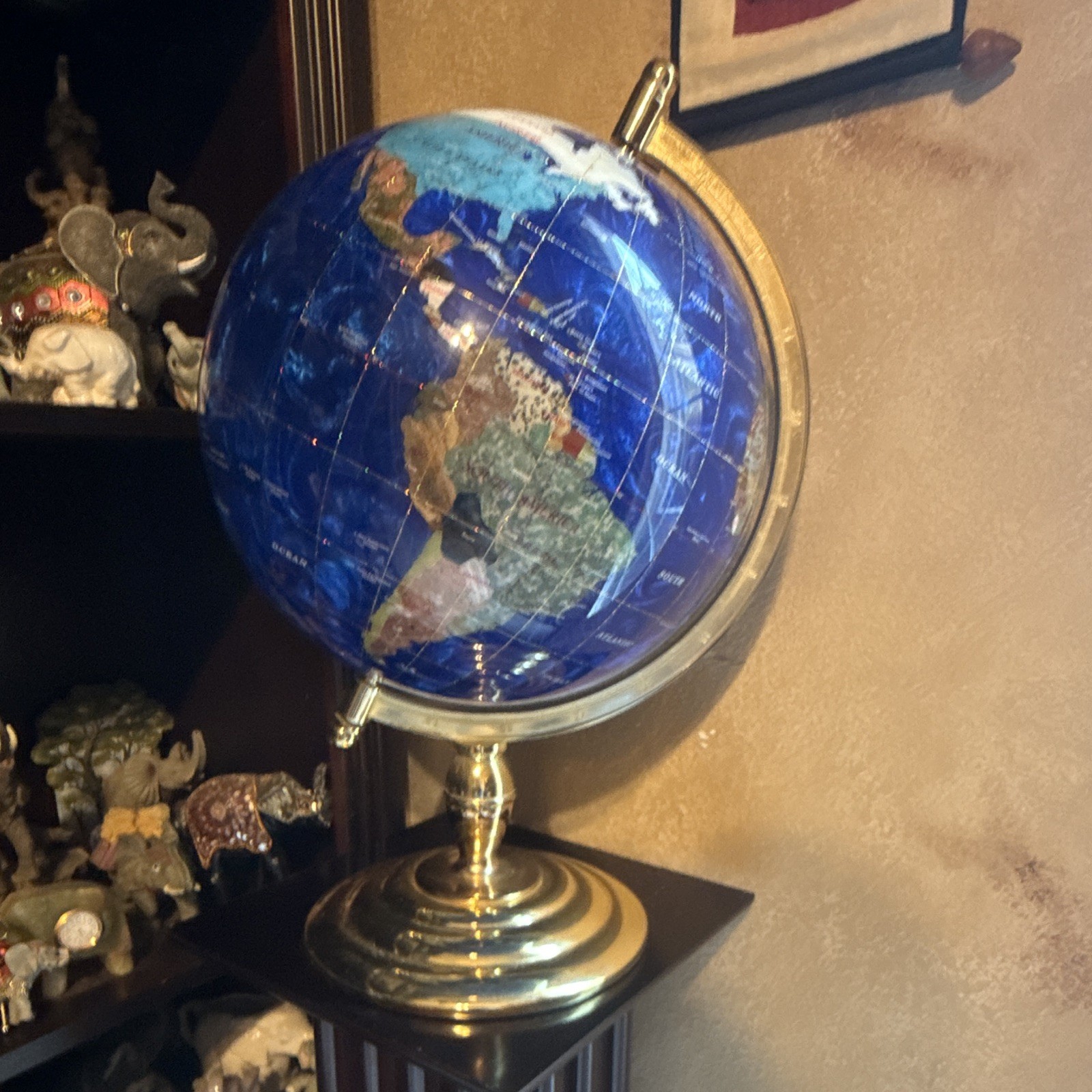 handcrafted semi-precious stone globe, often featuring oceans made of lapis lazu