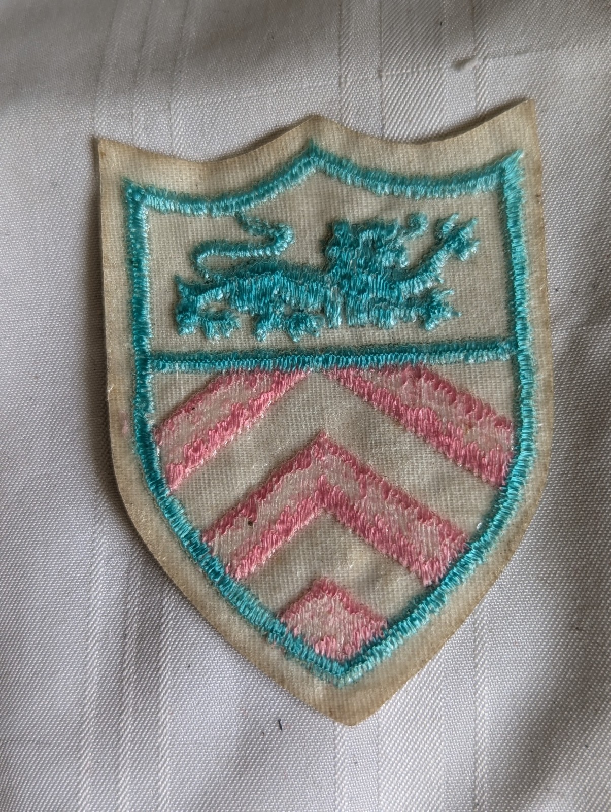 Shield shaped pink aqua blue lion embroidered patch 2.75" long
