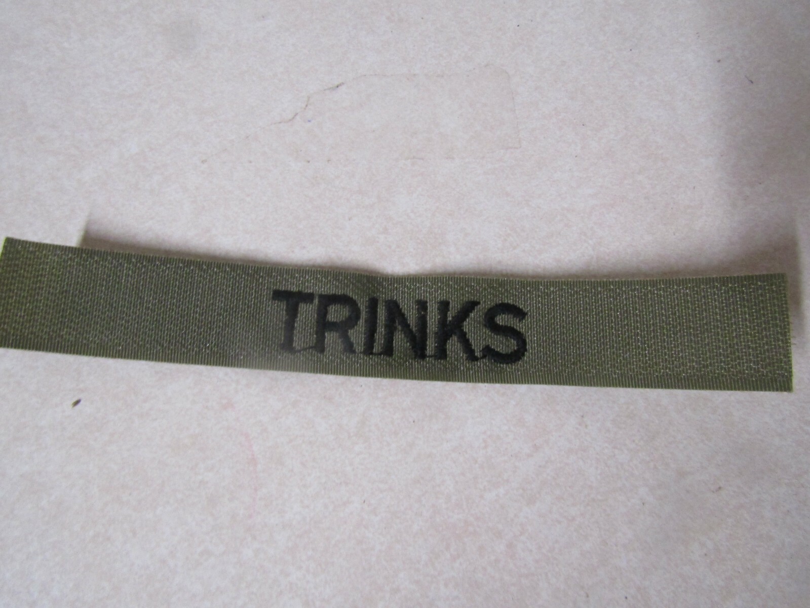 MILITARY PATCH OLDER SEW ON BDU OD GREEN NAME TAPE WITH TRINKS