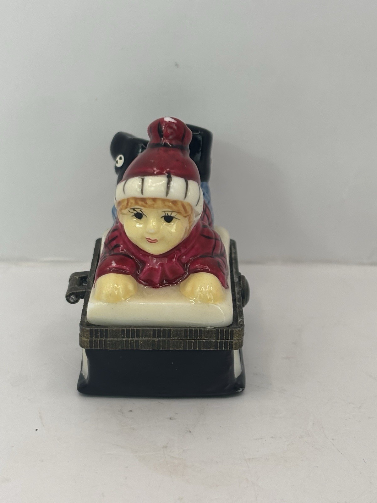 Ceramic Boy On Sled Hinged Trinket Box 2.5”