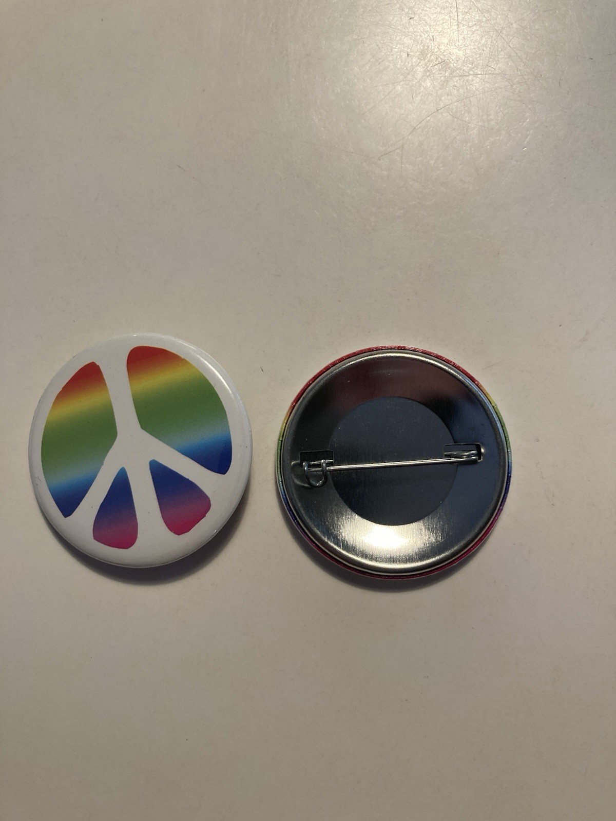 Peace symbol Pin with rainbow color across approx 1 11/16”