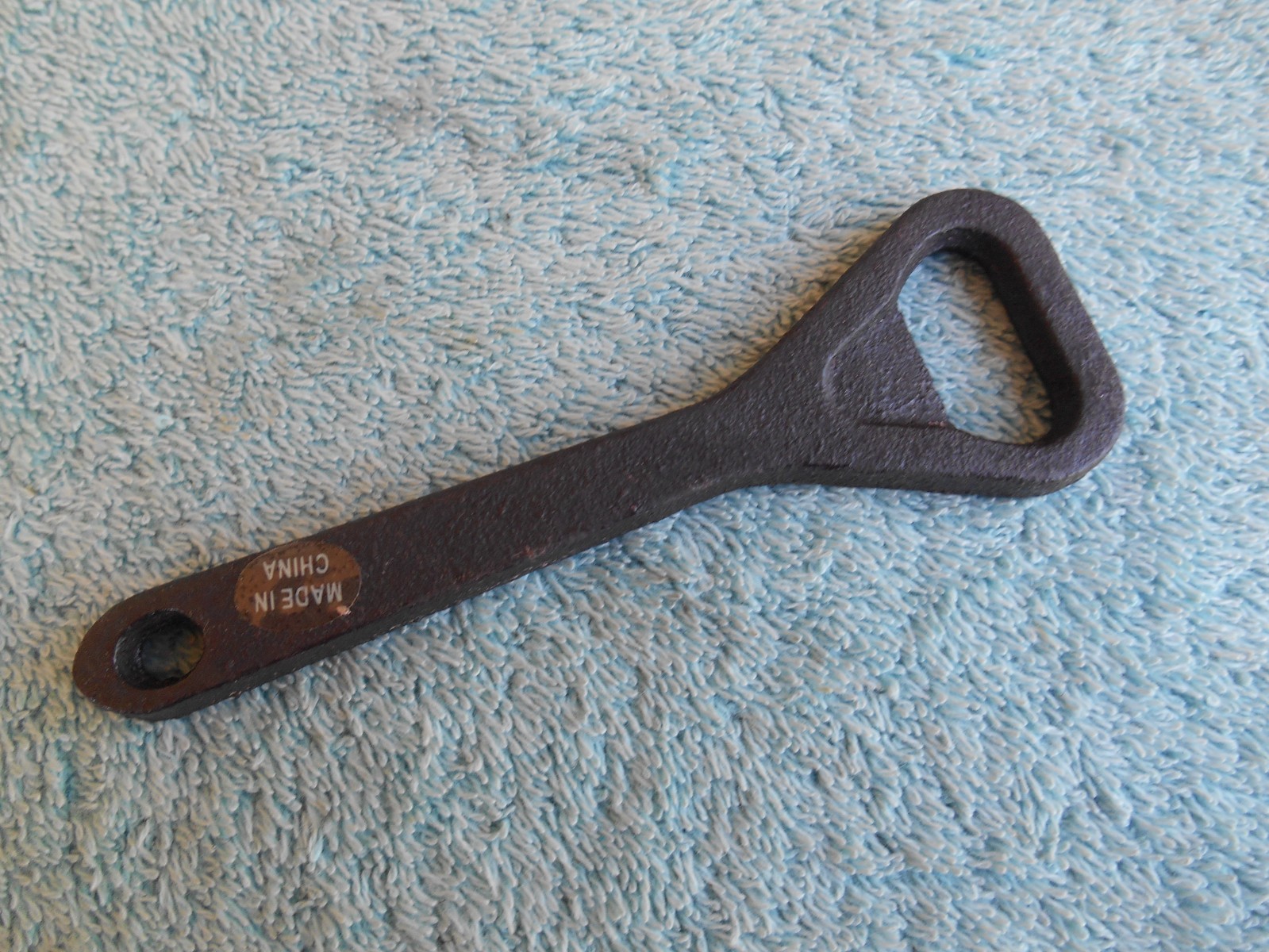 VINTAGE IRON BOTTLE OPENER MEASURES 4 1/2 INCHES. china.