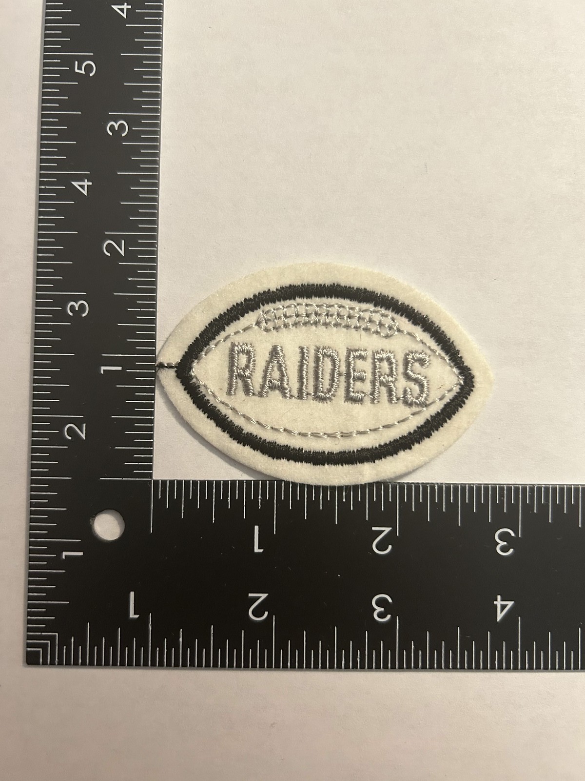1970s VINTAGE NFL FOOTBALL SHAPED 2.75"  PATCH RAIDERS SILVER TEXT BLACK BALL