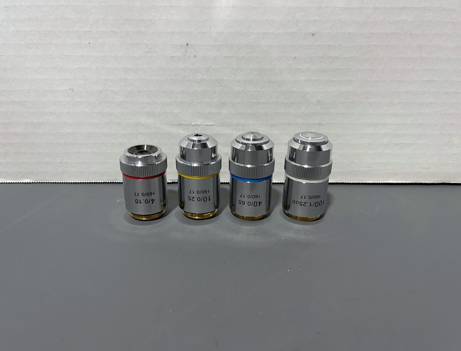 Lot of 4 Unbranded 4/0.10 10/025 40/0.65 100/1.25 oil Microscope Objectives