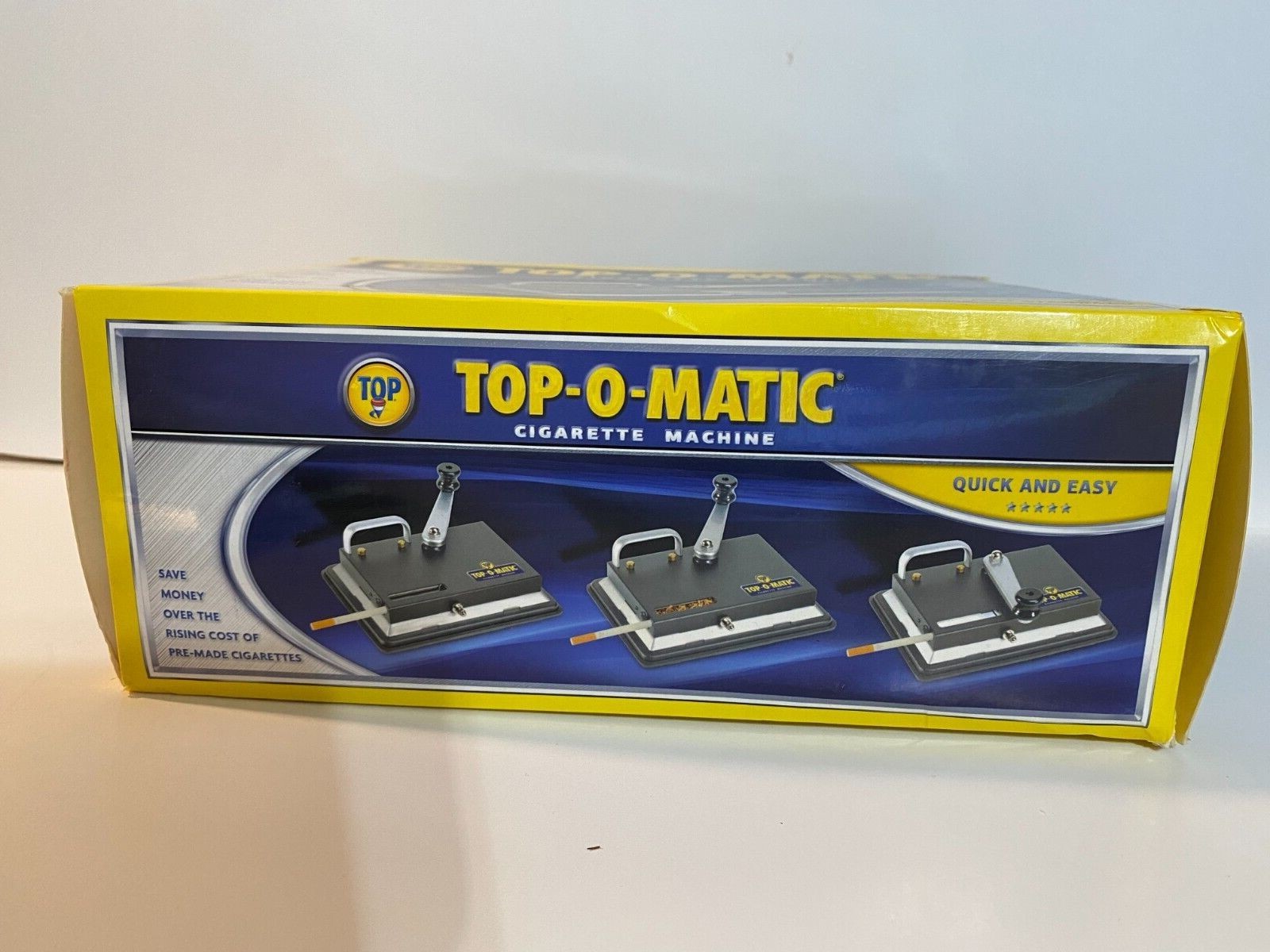 BRAND NEW, OPEN BOX, NEVER USED, TOP-O-MATIC CIGARETTE ROLLING MACHINE.