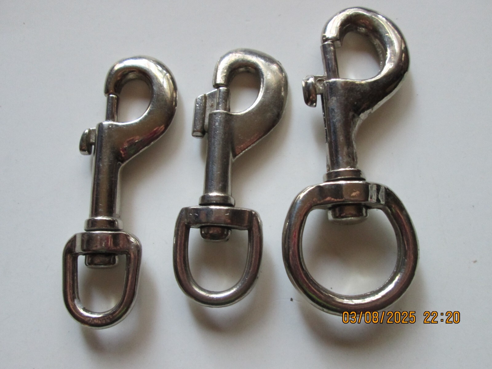 THREE [3] CHROME METAL SWIVEL SNAPS.