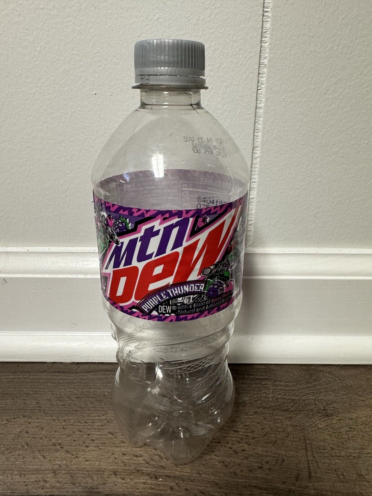 Empty Mountain Dew Purple Thunder 20 oz bottle