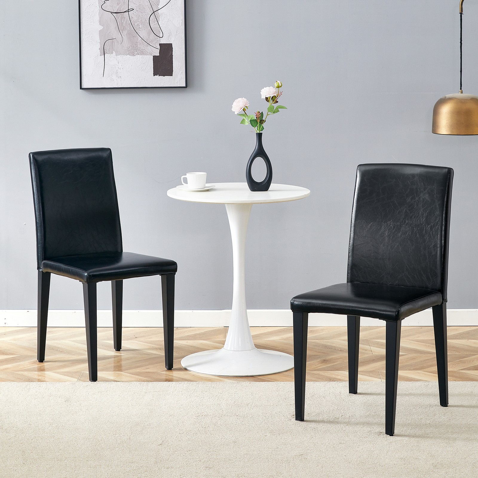 Two black PU dining chairs, simple and versatile, comfortable and accompanied.